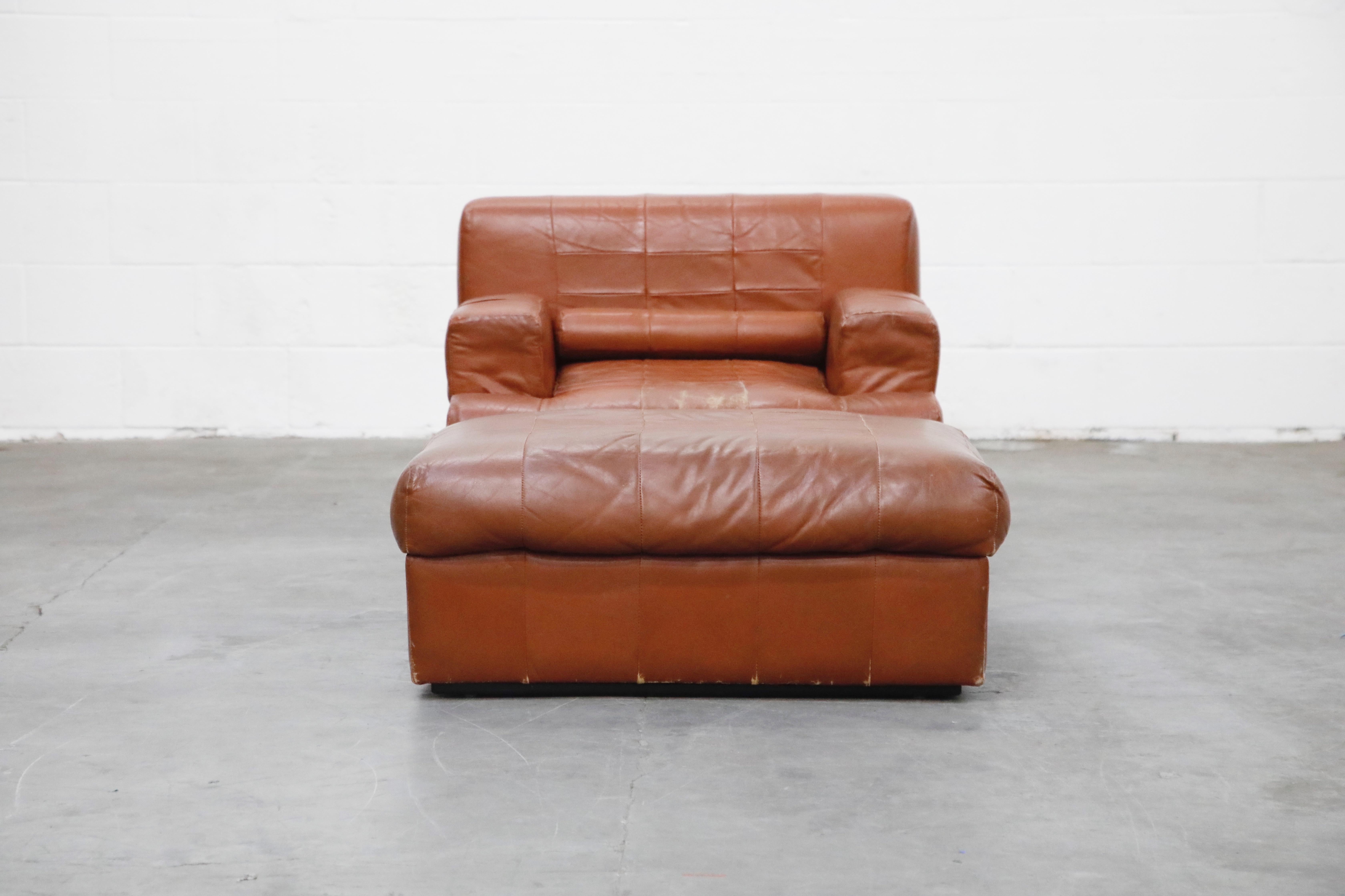 An impressive cognac colored leather lounge chair and ottoman by Brazilian designer Percival Lafer, with original labels, circa 1960 in original leather with moderate attractive patina and features a unique ability for the arms to transform up or