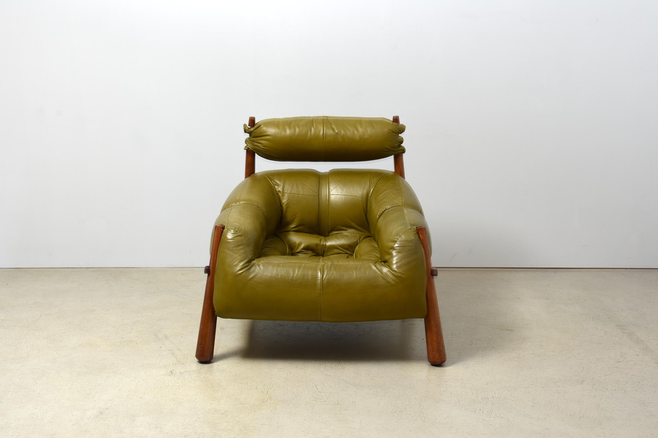 Super comfortable Brazilian lounge chair by designer Percival Lafer. Late 1950, jacaranda wood and olive green leather. The leather on the booth armrests has some minor wear. One of the jacaranda wood stick on the head rest has a minor crack.