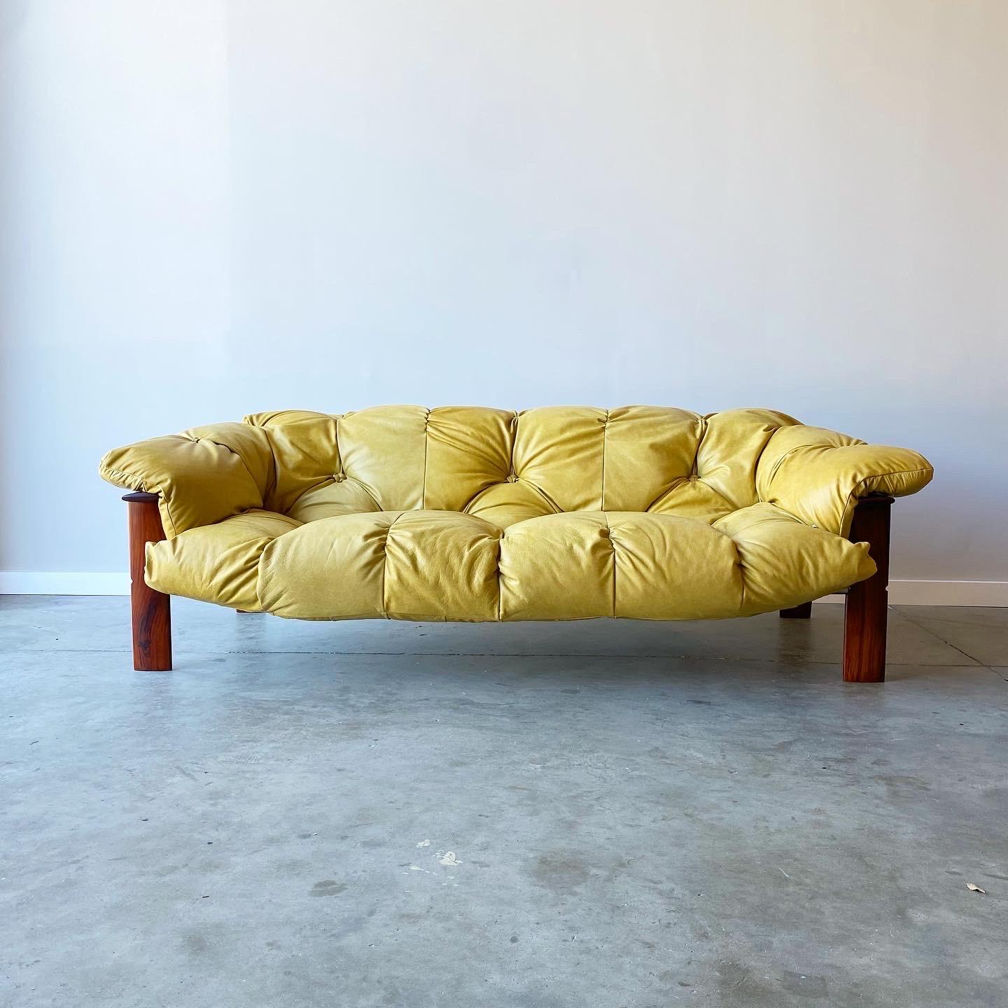 A stunning and rare example designed by Percival Lafer.  This sofa and ottoman have been fully restored with new leather and refinished Jacaranda frame.  The leather straps are in good original condition.  

A striking deep stance and extremely