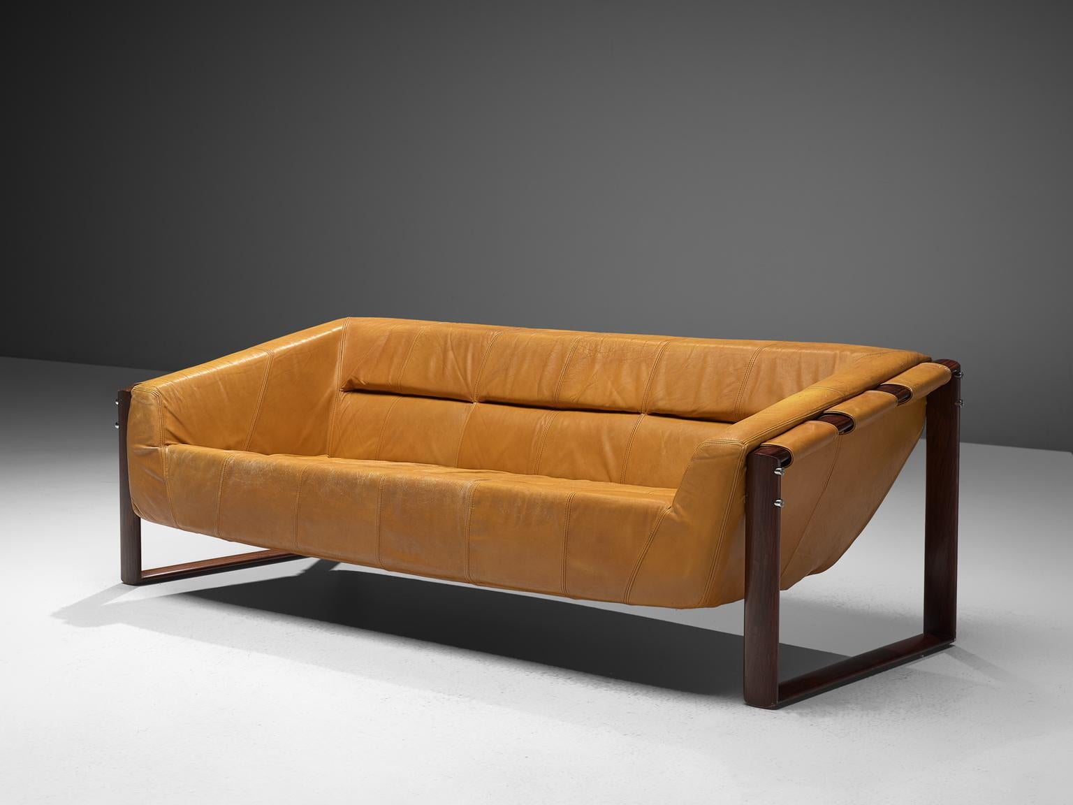 Percival Lafer, sofa, leather and rosewood, Brazil, late 1960s.

A wonderful three seat sofa by Brazilian designer Percival Lafer. This sofa consists of two geometric shaped rosewood frames, functioning as the legs and to hold up the actual seat