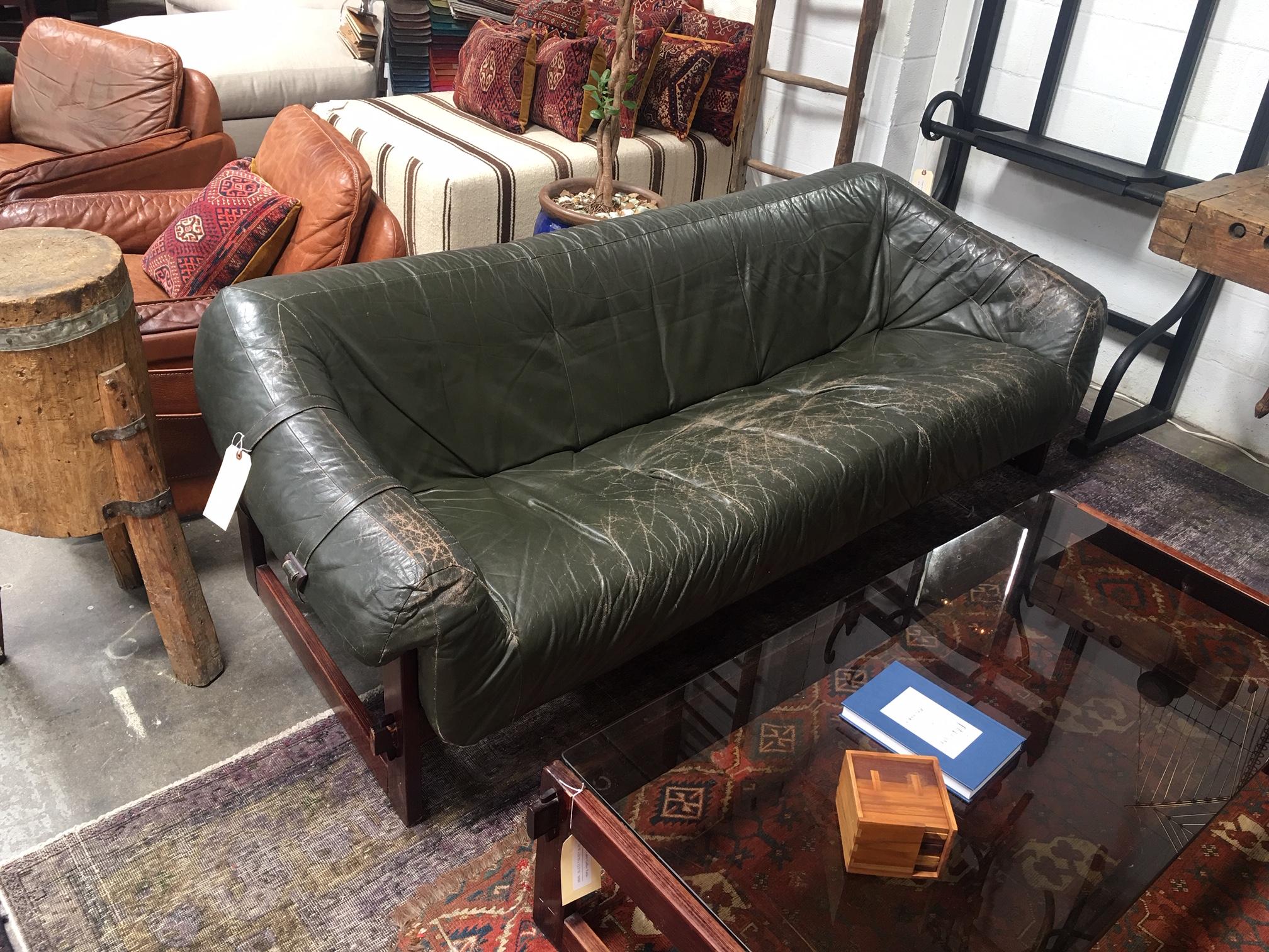 Beautiful Percival Lafer sofa in an emerald green leather. Leather shows patina consistent with the age of the piece.