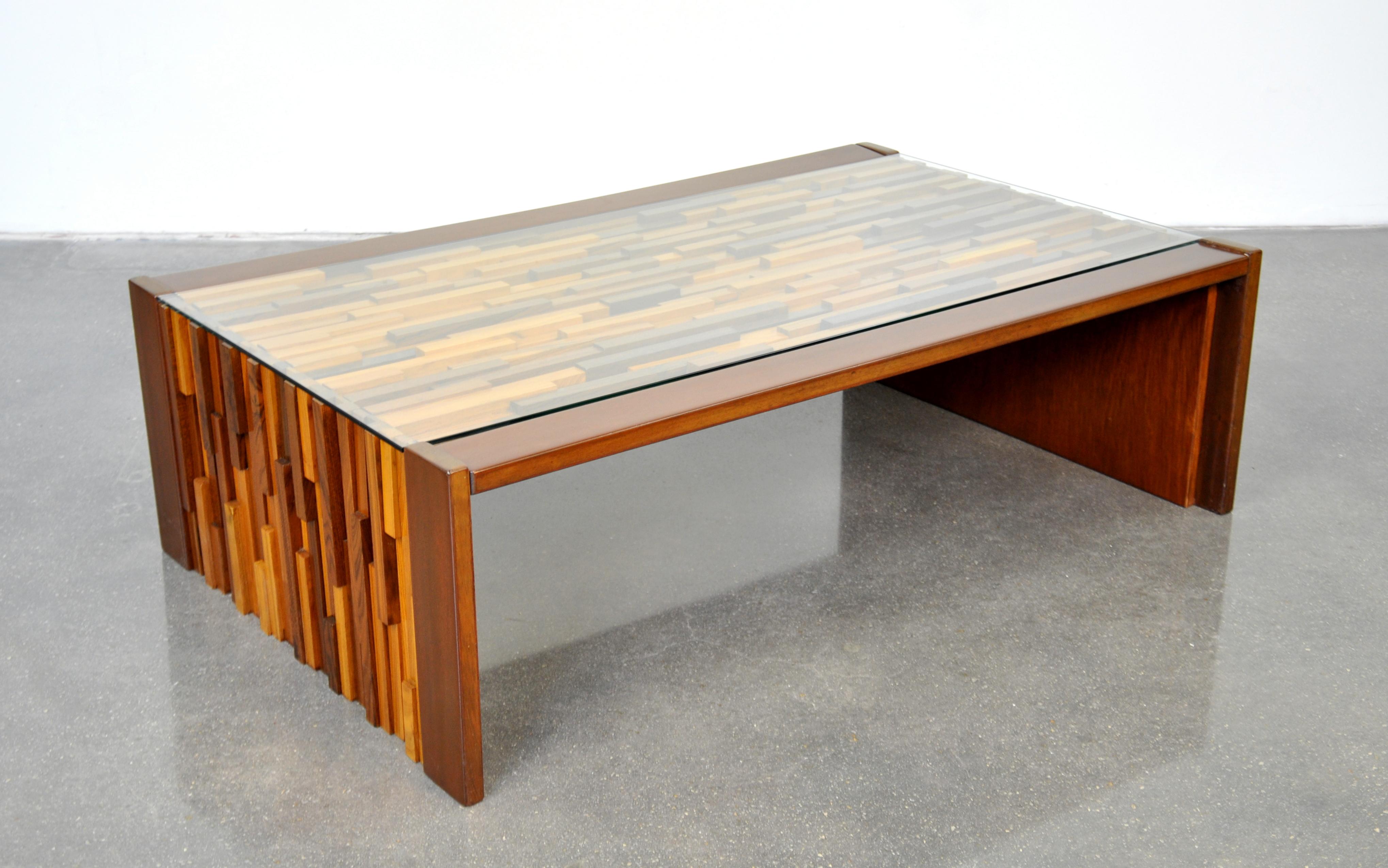 A striking vintage Mid-Century Modern Brazilian rosewood, jacaranda, teak and mahogany cocktail table designed by Percival Lafer, dating from the 1960s. The rectangular table features a sculptural relief of different exotic tropical hardwoods and a
