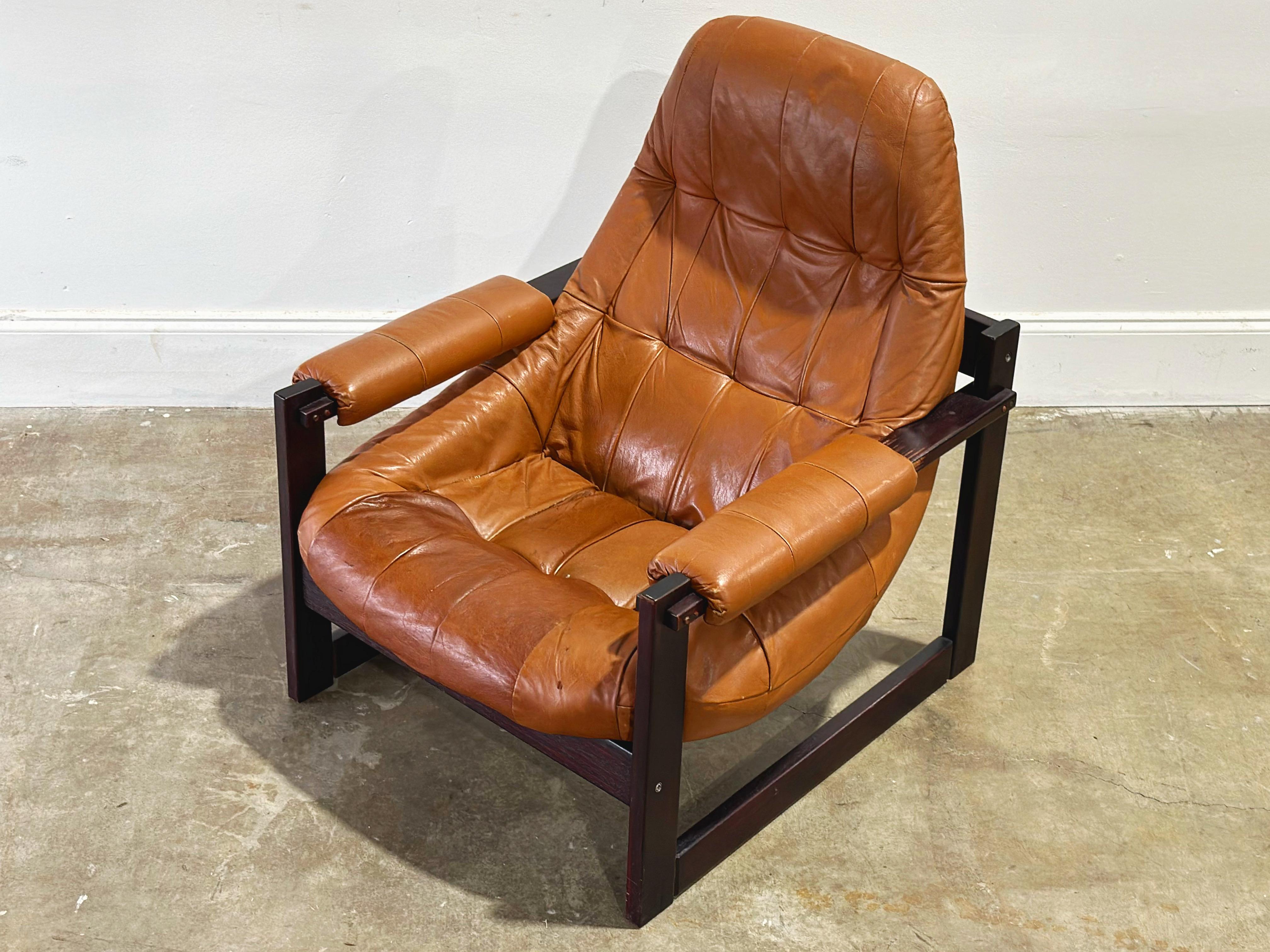 Earth chair with solid Jacaranda rosewood frame and cognac tone leather by Percival Lafer, Brazil circa 1970s. 
Frame is sound and secure. Leather displays a gorgeous patina. This chair does show wear but is in overall good condition. 

