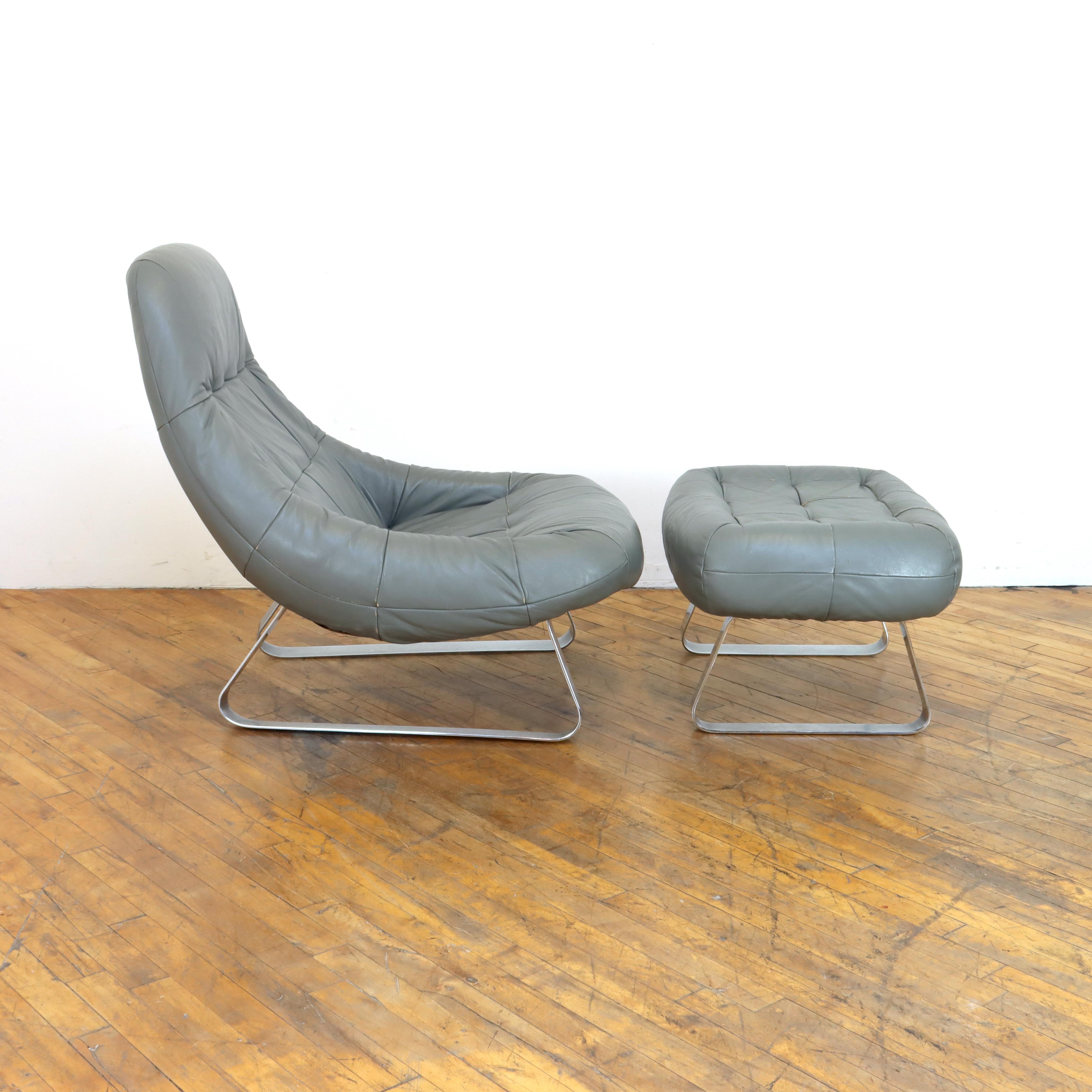 Lay back in this spaceship of a chair.  1970s Hippie futurist lounge chair and ottoman designed by Brazilian designer Percival Lafer.  Lafer is one of the most recognized Brazilian designers of his generation.  This set features an unusual grey