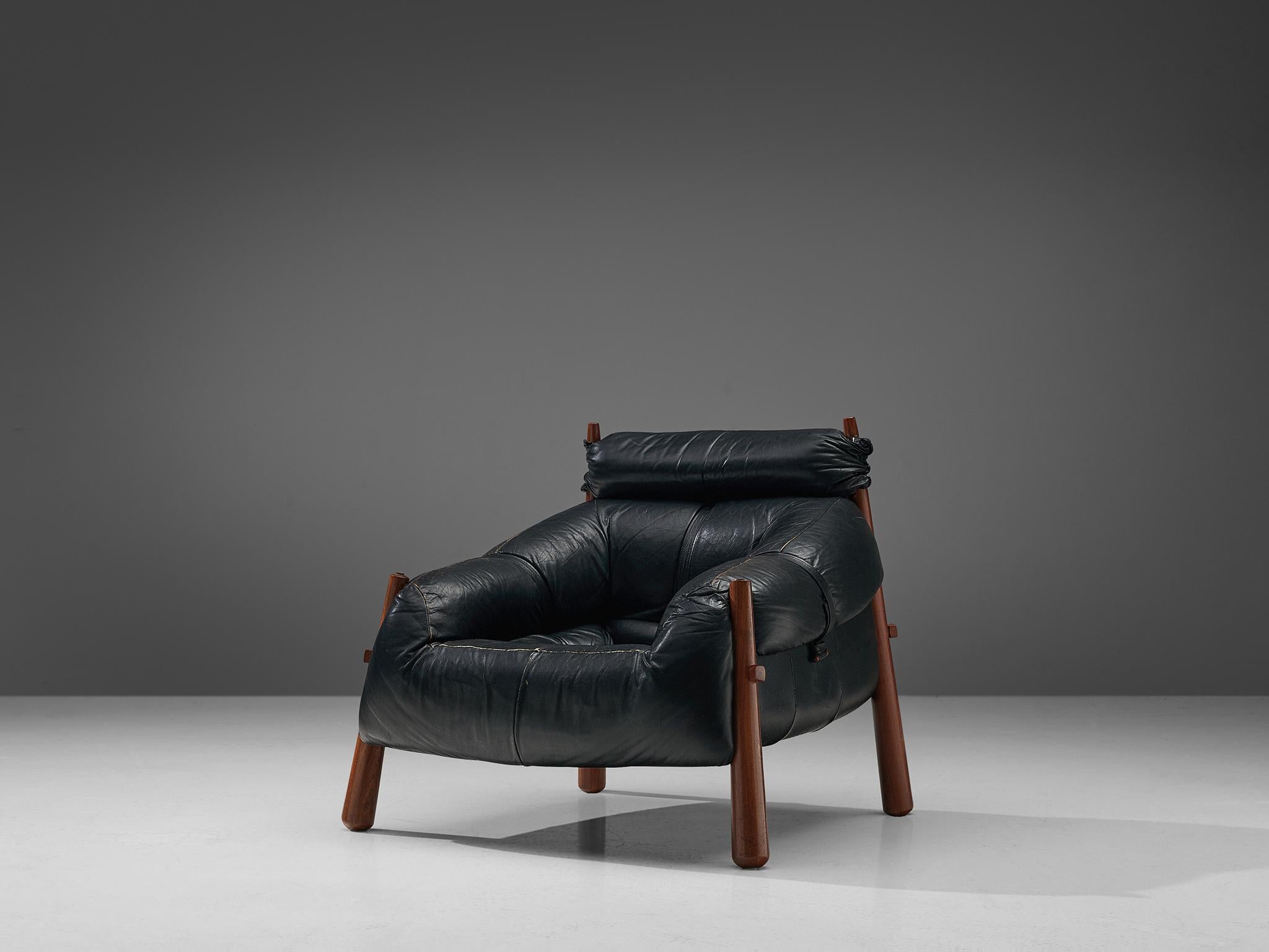 Percival Lafer, lounge chair model 'MP-81', leather and Brazilian walnut, Brazil, 1972. 

Beautiful lounge chair by Brazilian designer Percival Lafer. These chairs consist of a solid wooden base to which the leather seating is attached. The tufted