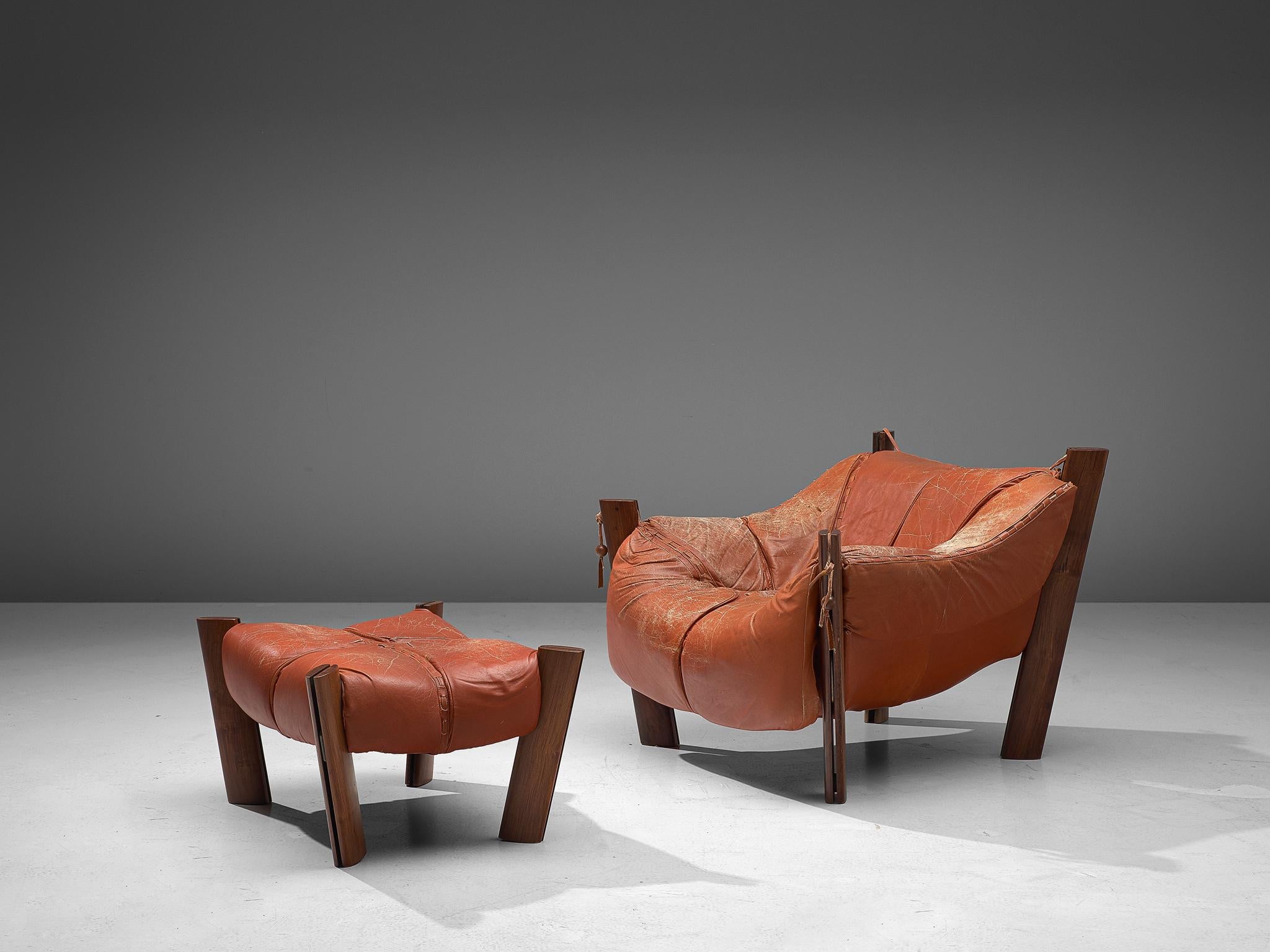 Percival Lafer, lounge chair with ottoman model MP-211, in wood and leather, Brazil, 1974.

Lounge chair by Brazilian designer Percival Lafer. This sofa consists of a solid wood base in which the leather seating 'hangs'. Soft cushions are folded