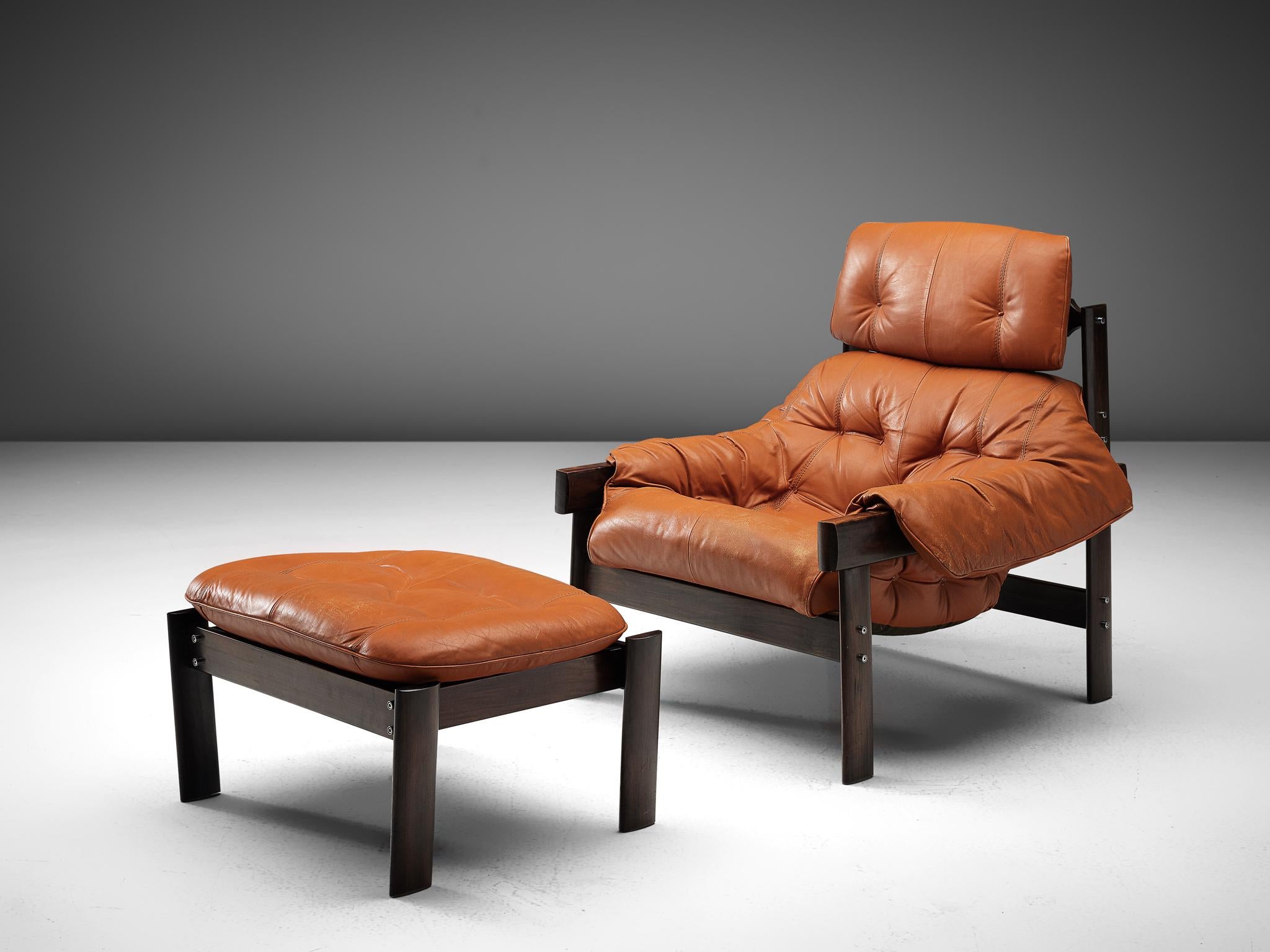 Percival Lafer, lounge chair with ottoman, leather, dark stained wood, Brazil, late 1970s

Bulky and voluptuous lounge chair with pouf by Brazilian designer Percival Lafer. This chair features a solid dark wooden base with leather straps spanned