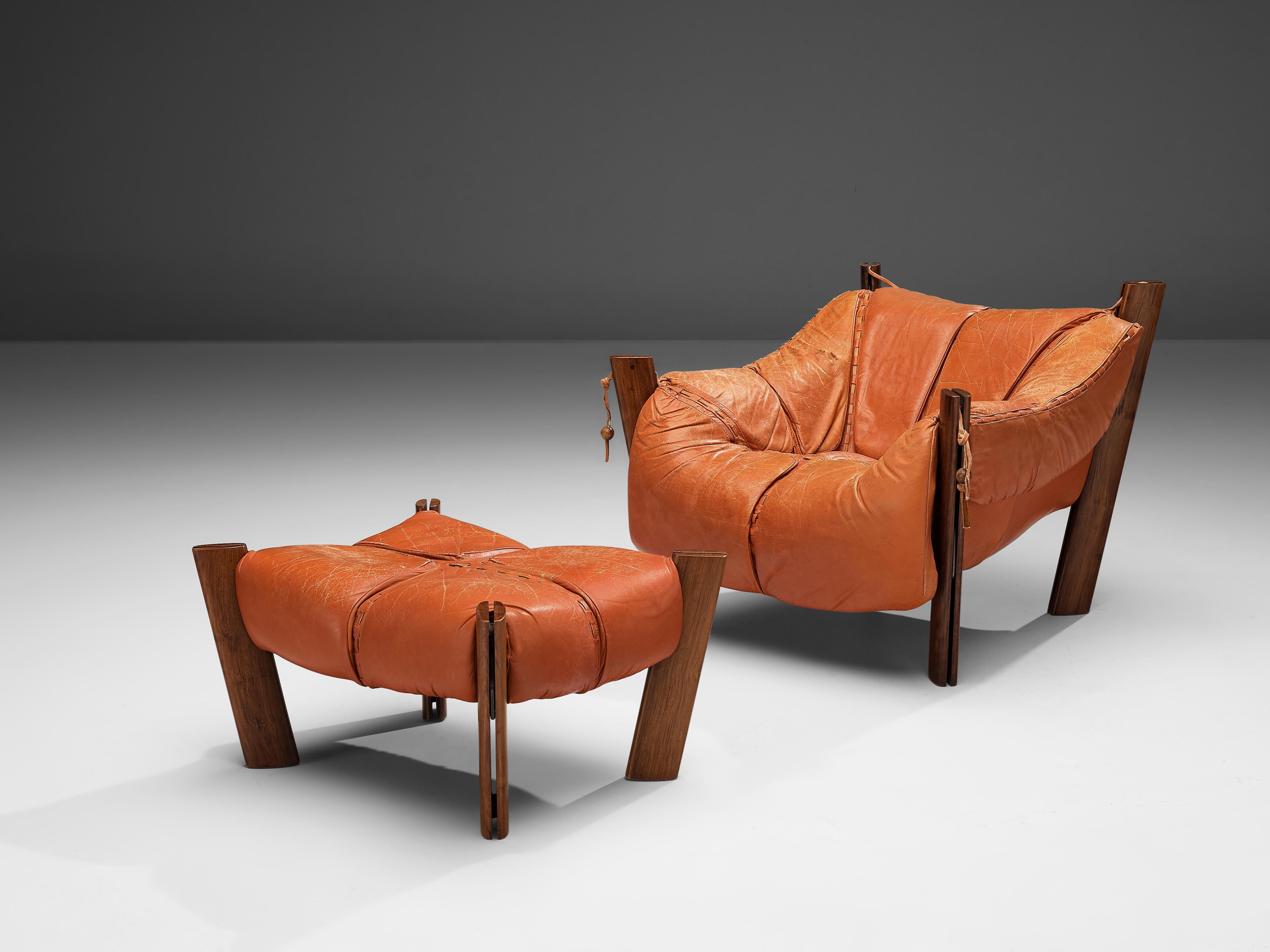 Percival Lafer, lounge chair with ottoman, model MP-211, hardwood, leather, Brazil, 1974

Bulky and volominous lounge chair with pouf by Brazilian designer Percival Lafer. This chair features a solid dark wooden base with leather seating spanned