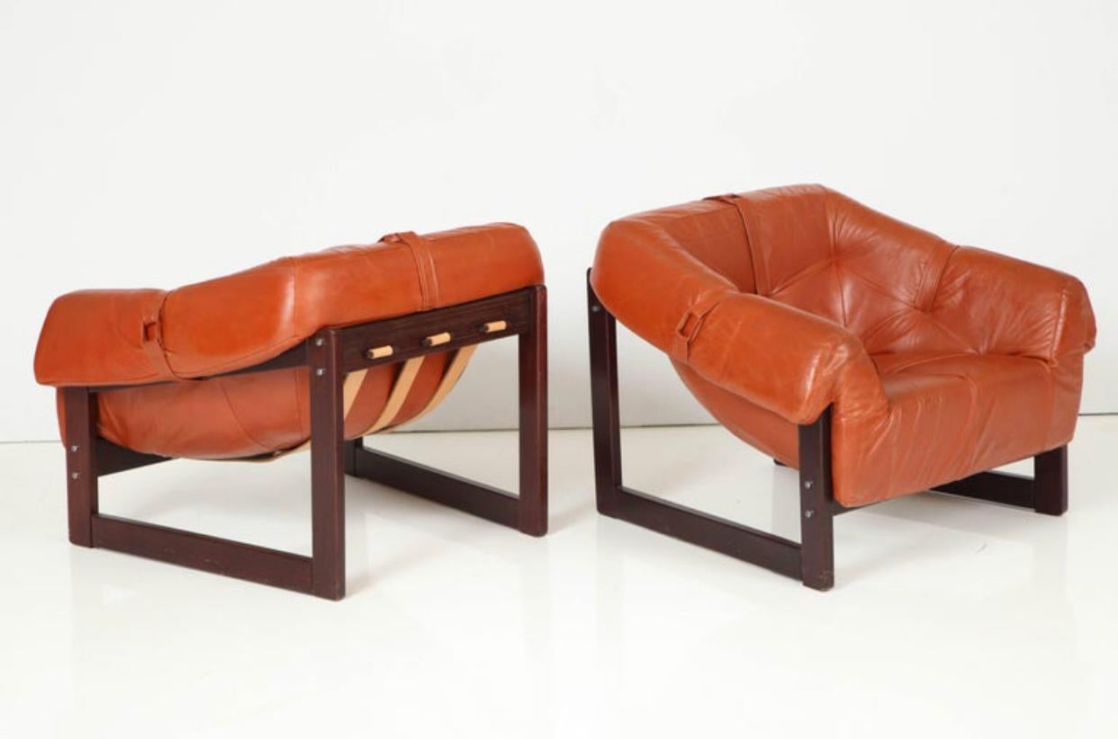 Percival Lafer lounge chairs model MP-091. Original caramel leather on Brazilian cherrywood frames. In good original condition, all completely original.