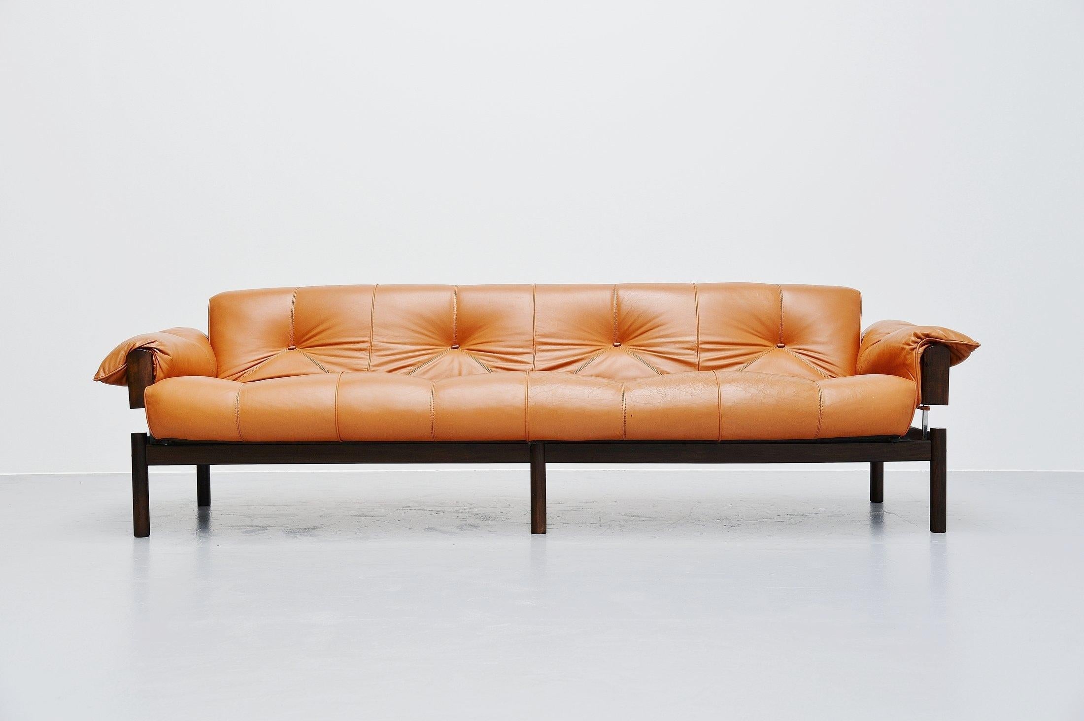 Very nice MP-13 lounge sofa designed and manufactured by Percival Lafer, Brazil, 1960. This sofa has a stained beech wooden frame which supports the cognac leather seat. The sofa has some nice chrome-plated details that keep everything in place.