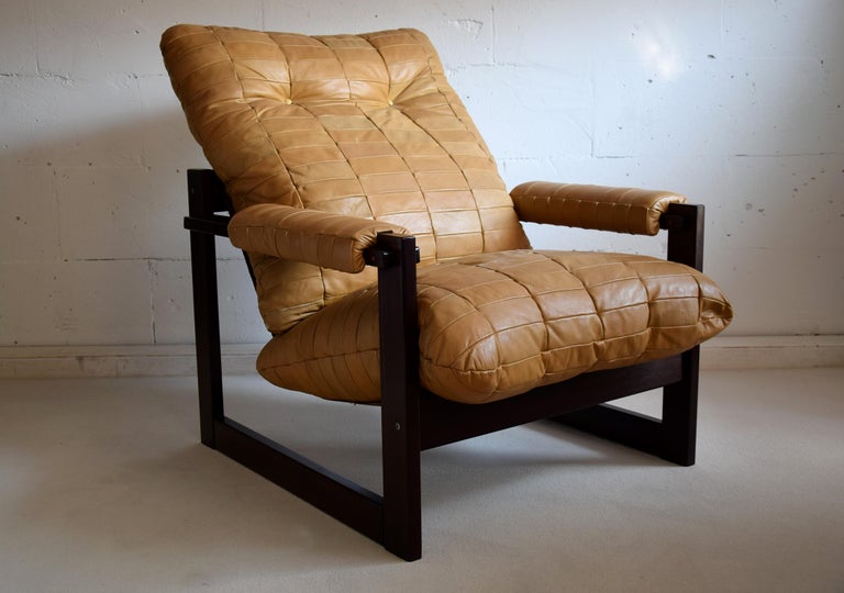 Stylish Mid-Century Modern lounge chair designed and produced by Percival Lafer In Sào Paulo Brazil. The Brazilian mahogany structure is in good condition and the chair still has it's original camel color leather upholstery. This chair was made on