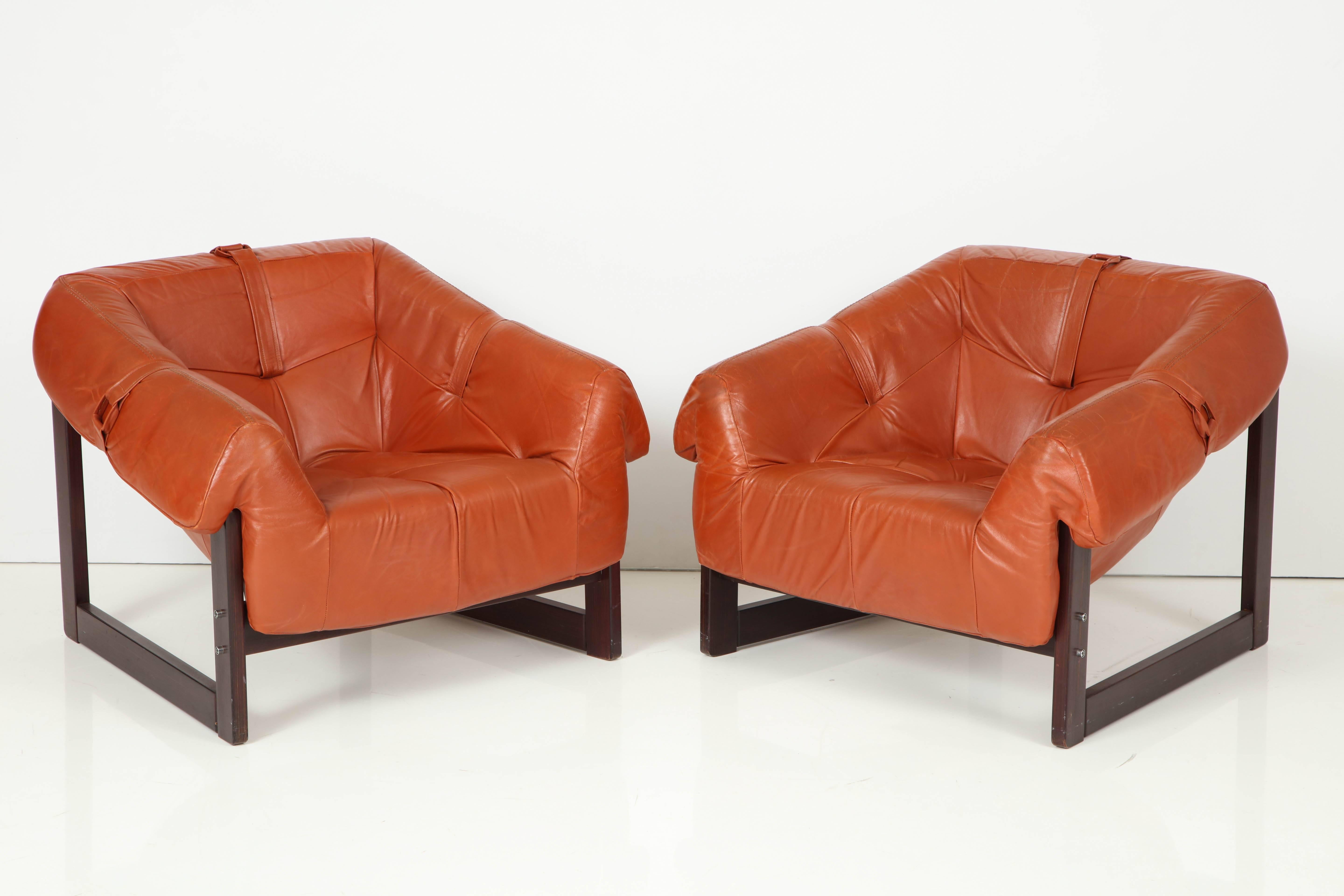 An all original pair of MP-091 loungers by Percival Lafer in Brazilian cherry and completely original caramel colored leather with original arm holding straps.