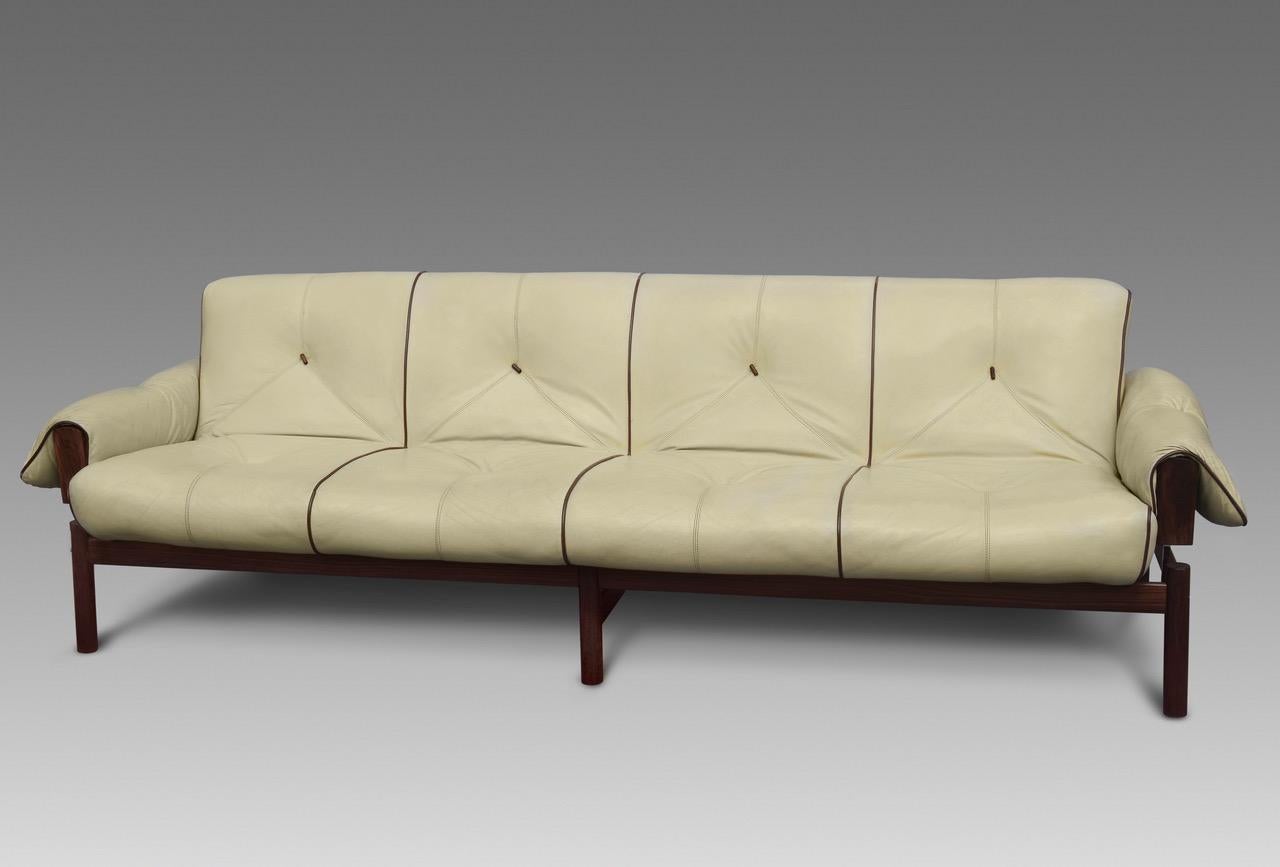 Introducing the MP-13 Four-Seat Sofa by Brazilian designer Percival Lafer, a true masterpiece of mid-century modern design. This stunning sofa, designed in 1967, features a gorgeous Jatoba wooden frame with vivid grain, exuding warmth and natural