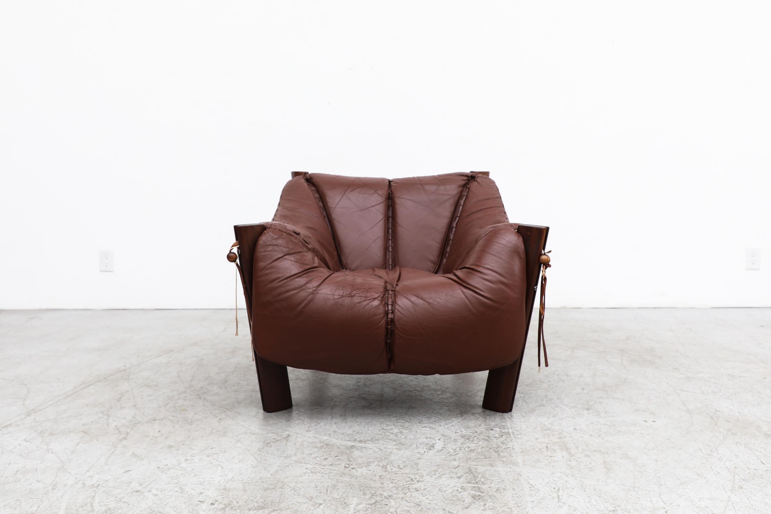 Iconic design by prolific Brazilian designer pioneer of the Modernist movement, Percival Lafer. 
Showcasing his trademark use of gorgeous, solid hardwoods, leather upholstery and meticulous finishing details the MP-211 lounge chair stunningly uses