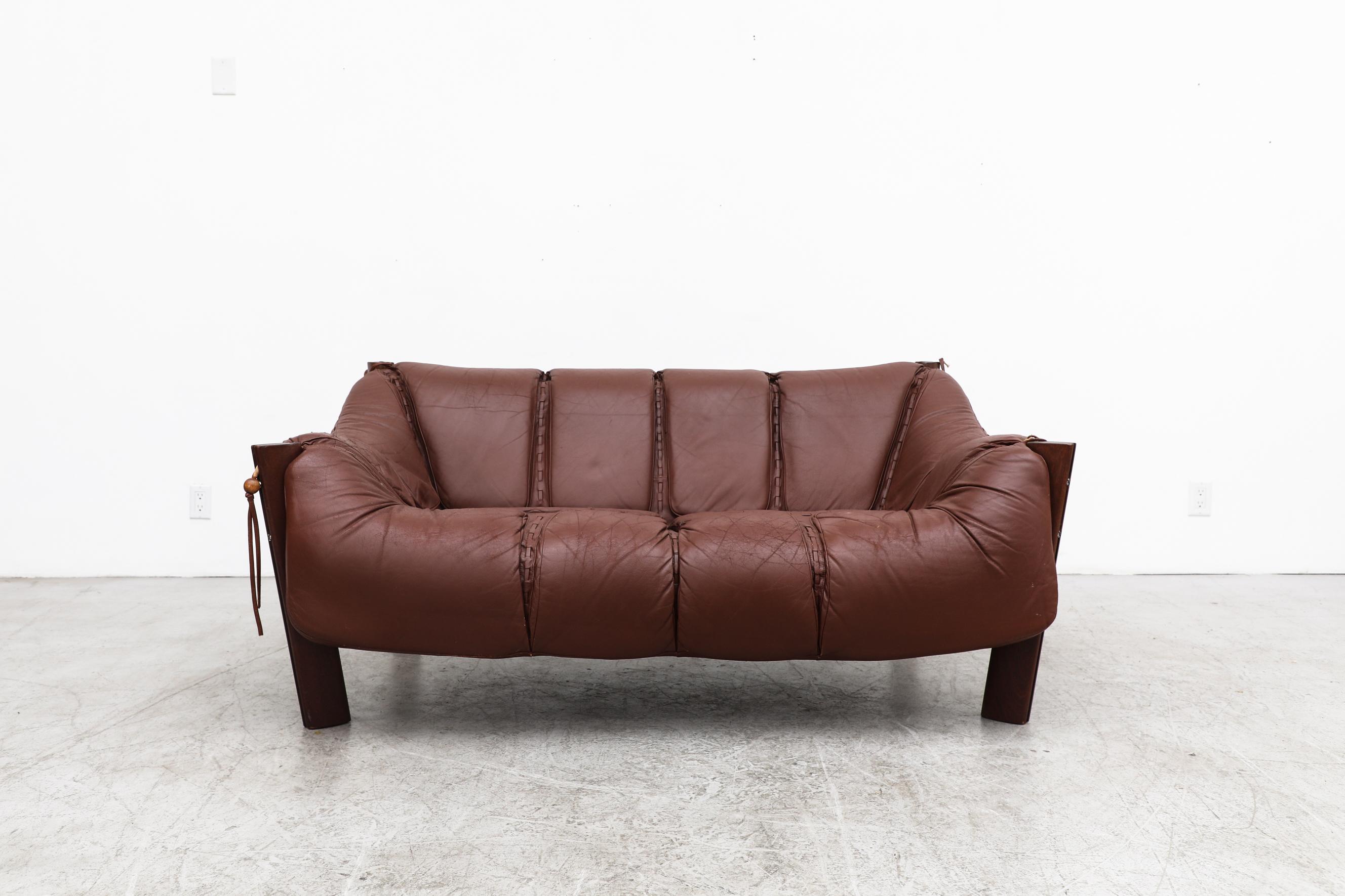 Iconic design by prolific Brazilian designer pioneer of the Modernist movement, Percival Lafer. 
Showcasing his trademark use of gorgeous, solid hardwoods, leather upholstery and meticulous finishing details the MP-211 loveseat stunningly uses