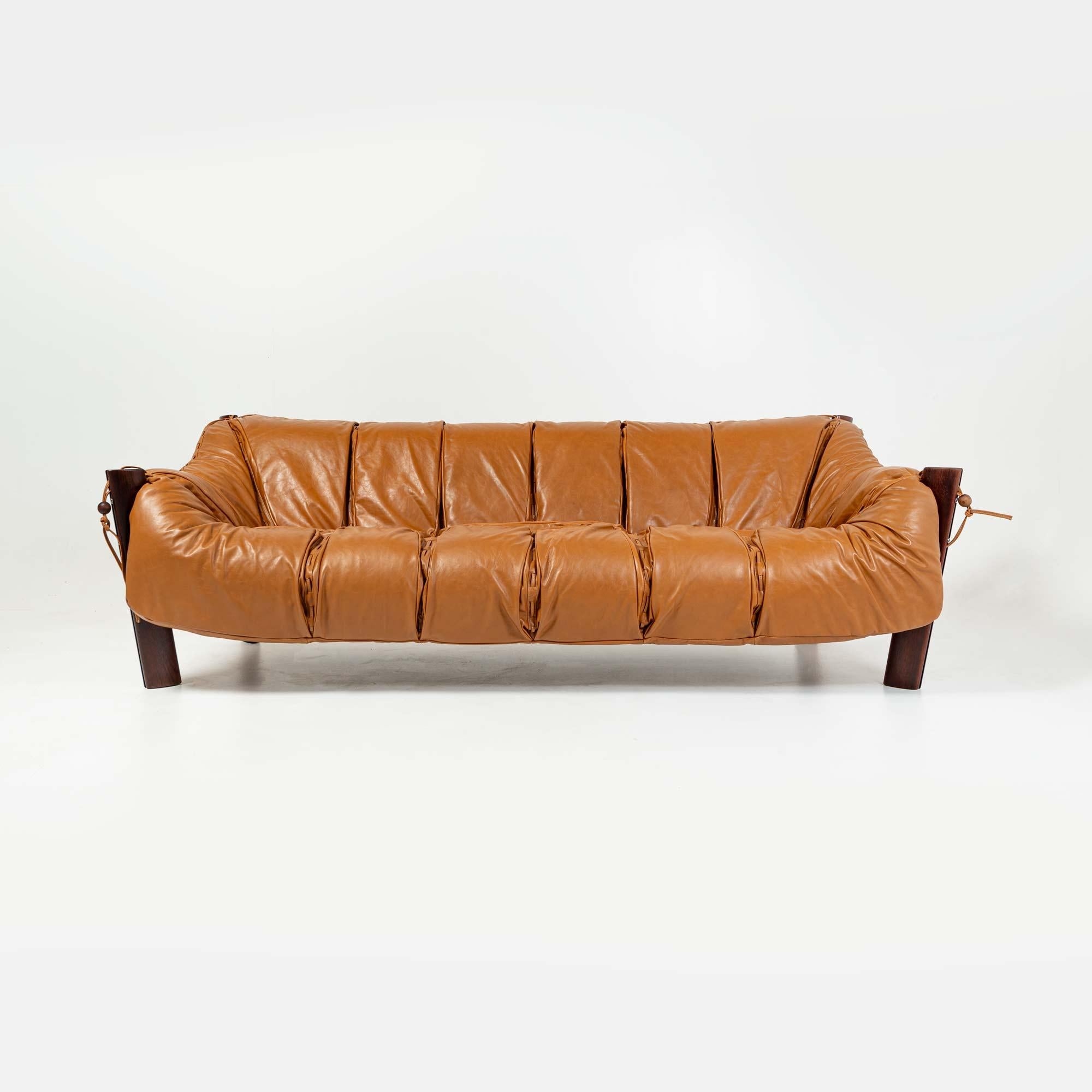 A highly sought after Percival Lafer three seater sofa model MP-211 in original Brazilian rosewood wood and re-upholstered in Maharam Sorghum cognac leather. In his unique designs, Lafer sought ergonomy and comfort making this sofa a true statement.