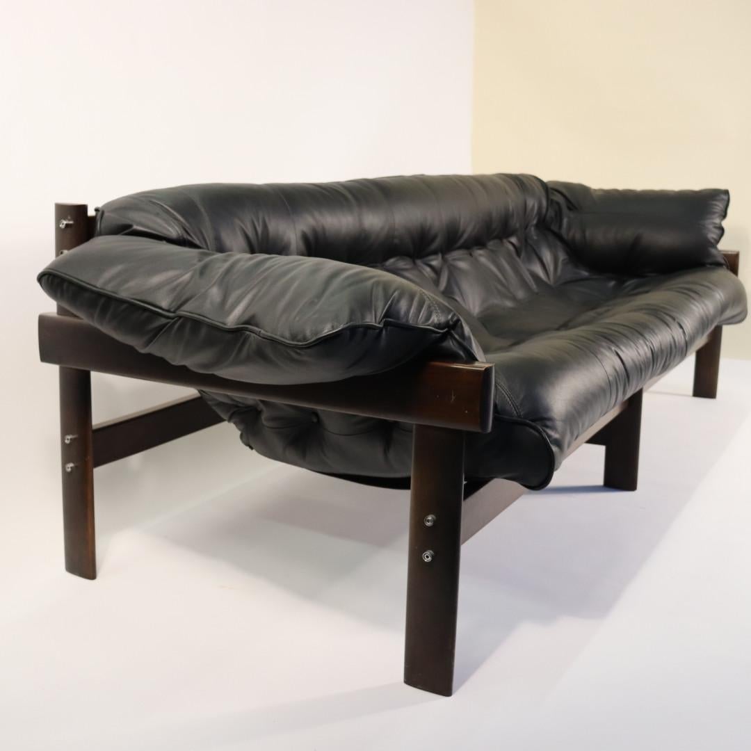 We have just reupholstered this sofa in a super soft black leather. Percival Lafer wanted the sitter to feel like you were floating in a hammock and this sofa really delivers, it is a perfectly comfortable sofa, nap couch and elegant from all