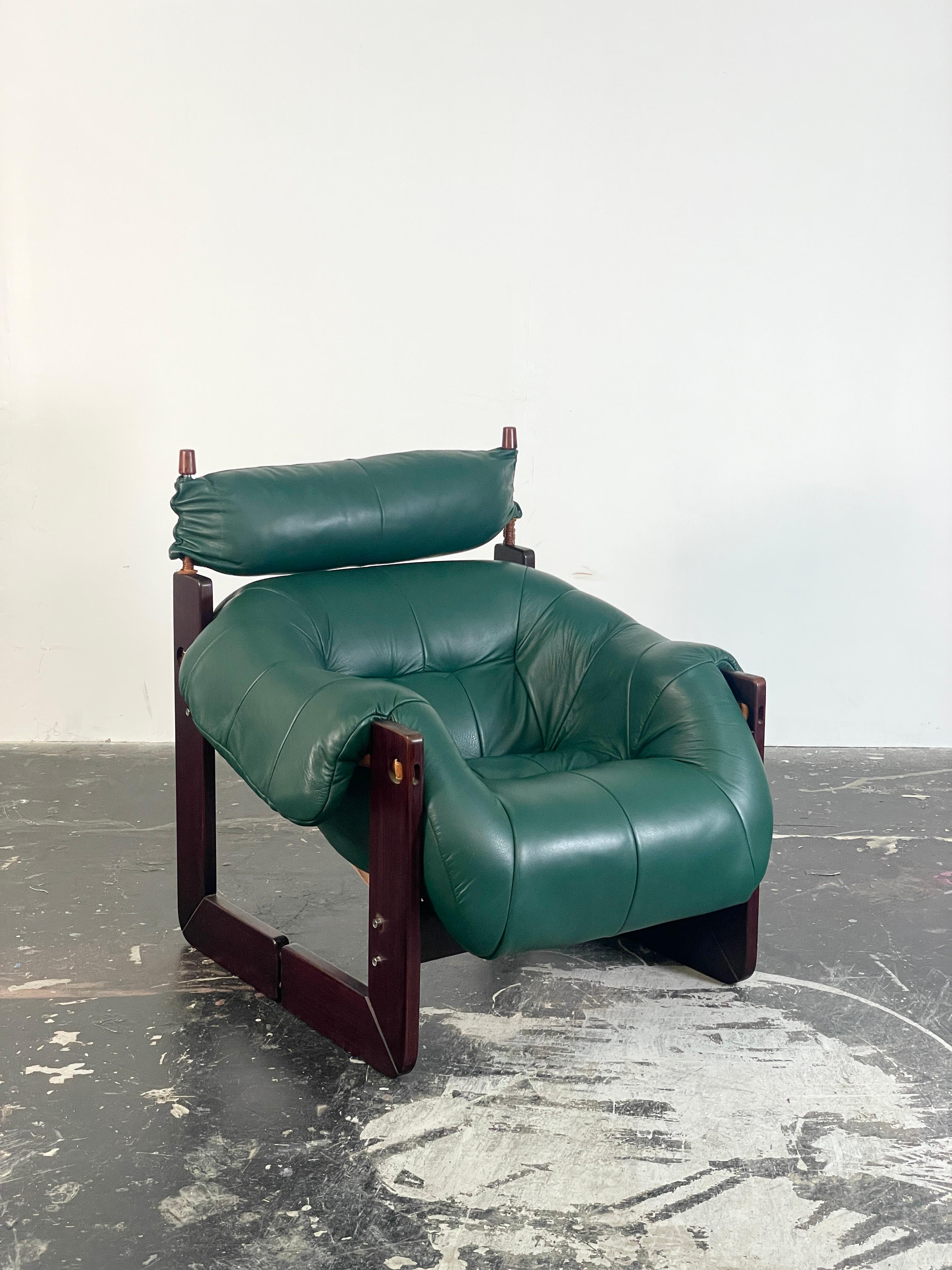 This Brazilian Modern Lounge chair could not be more comfortable! The MP-97 was designed by Percival Lafer. With its solid jacaranda hardwood frame, original leather straps, and new green leather. We have reupholstered this to match the original