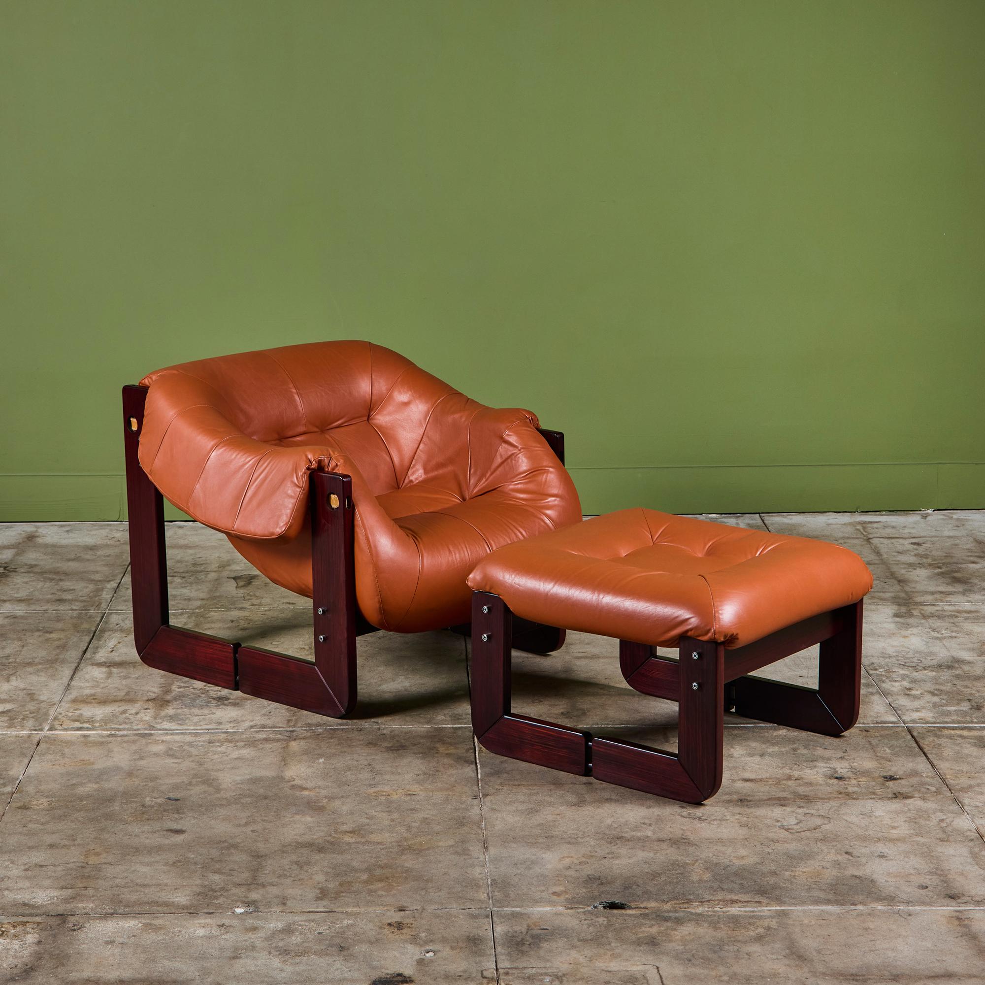 Leather lounge chair and ottoman set by Percival Lafer c.1960's, Brazil. The chair and ottoman feature the original cognac leather with a beautiful Brazilian hardwood frame. The back of the lounge chair showcases leather strapping, while the seat