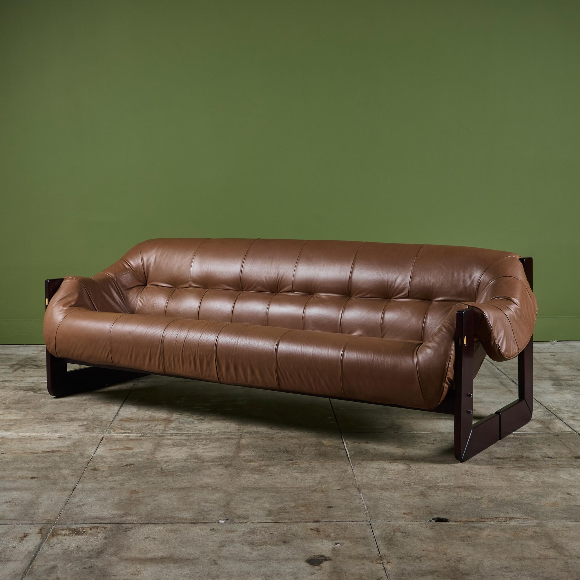 Leather sofa by Percival Lafer c.1960's, Brazil. The sofa features the original cognac brown leather seat with a beautiful Brazilian hardwood frame. The back of the sofa showcases leather strapping while the seat has gorgeous tufting