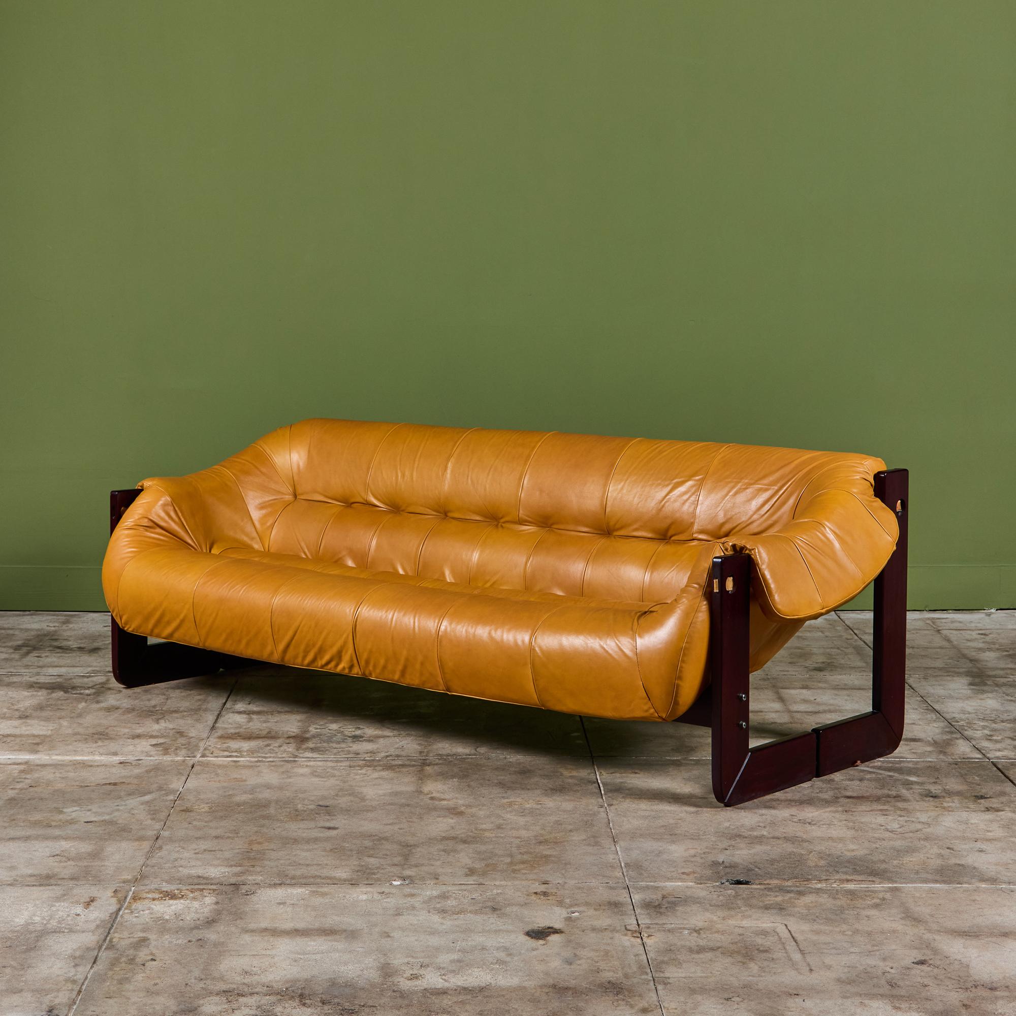Leather sofa by Percival Lafer c.1960's, Brazil. The sofa features the original mustard yellow leather seat with a beautiful Brazilian hardwood frame. The back of the sofa showcases leather strapping, while the seat has gorgeous tufting
