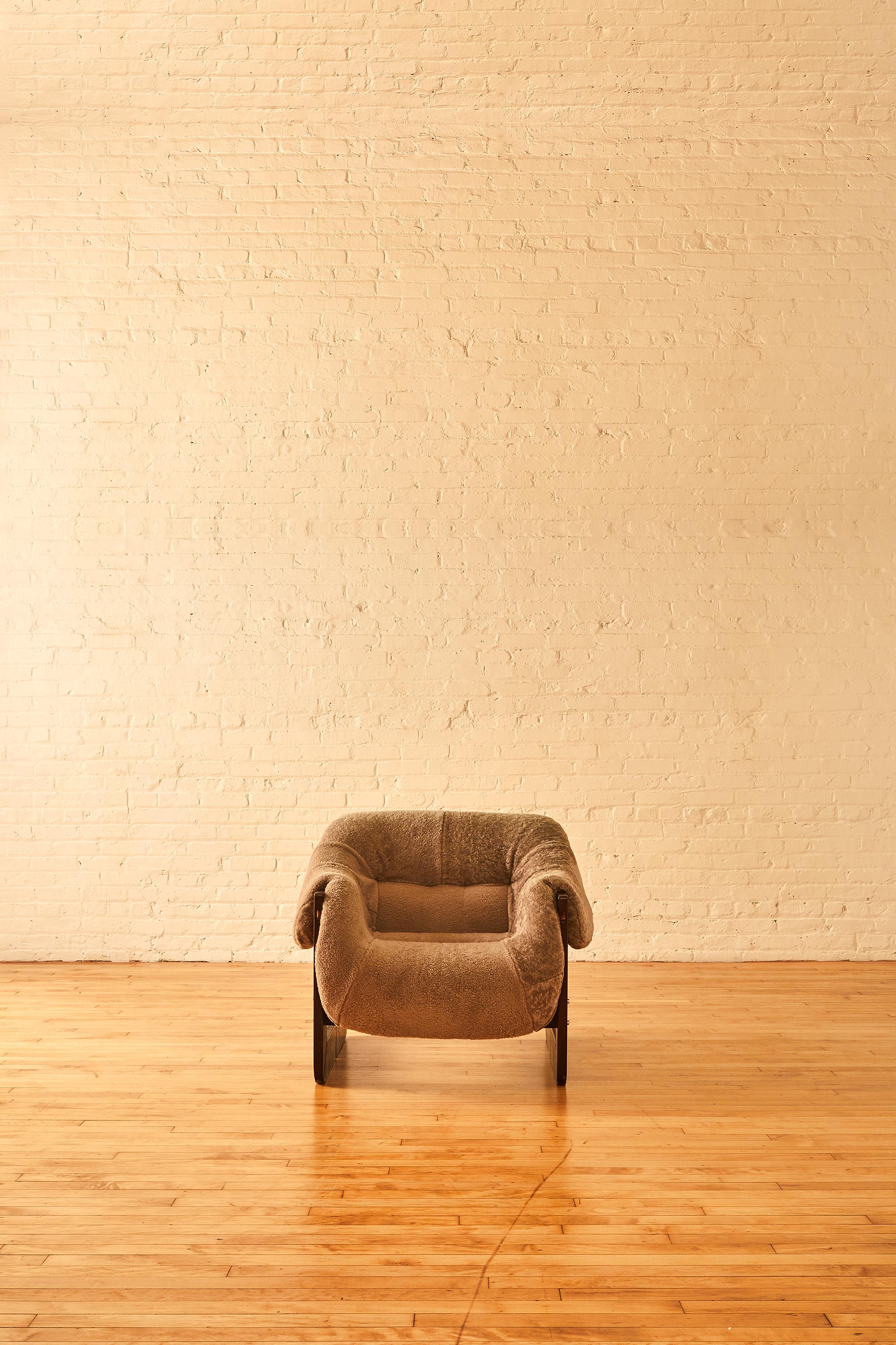 Percival Lafer MP-97 lounge chair with lush grey shearling upholstery. The chair is composed of jatoba wood, and features leather straps, and foam padding.


