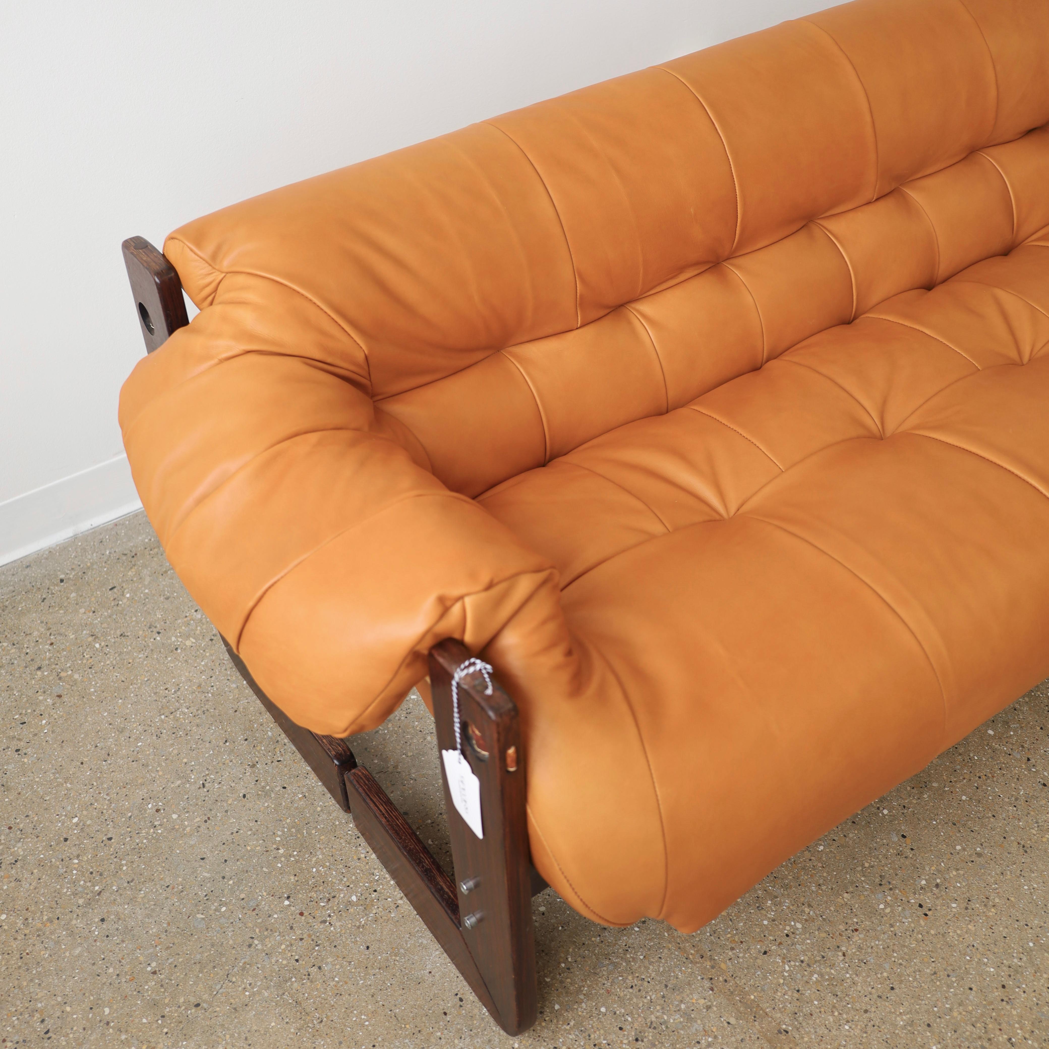 c. 1970s, Brazil. This piece has been fully restored in Spinneybeck leather and features new straps. The wood frame has been left original to preserve its’ patina. There are small blemishes including scratches and finish loss. Leather is also a