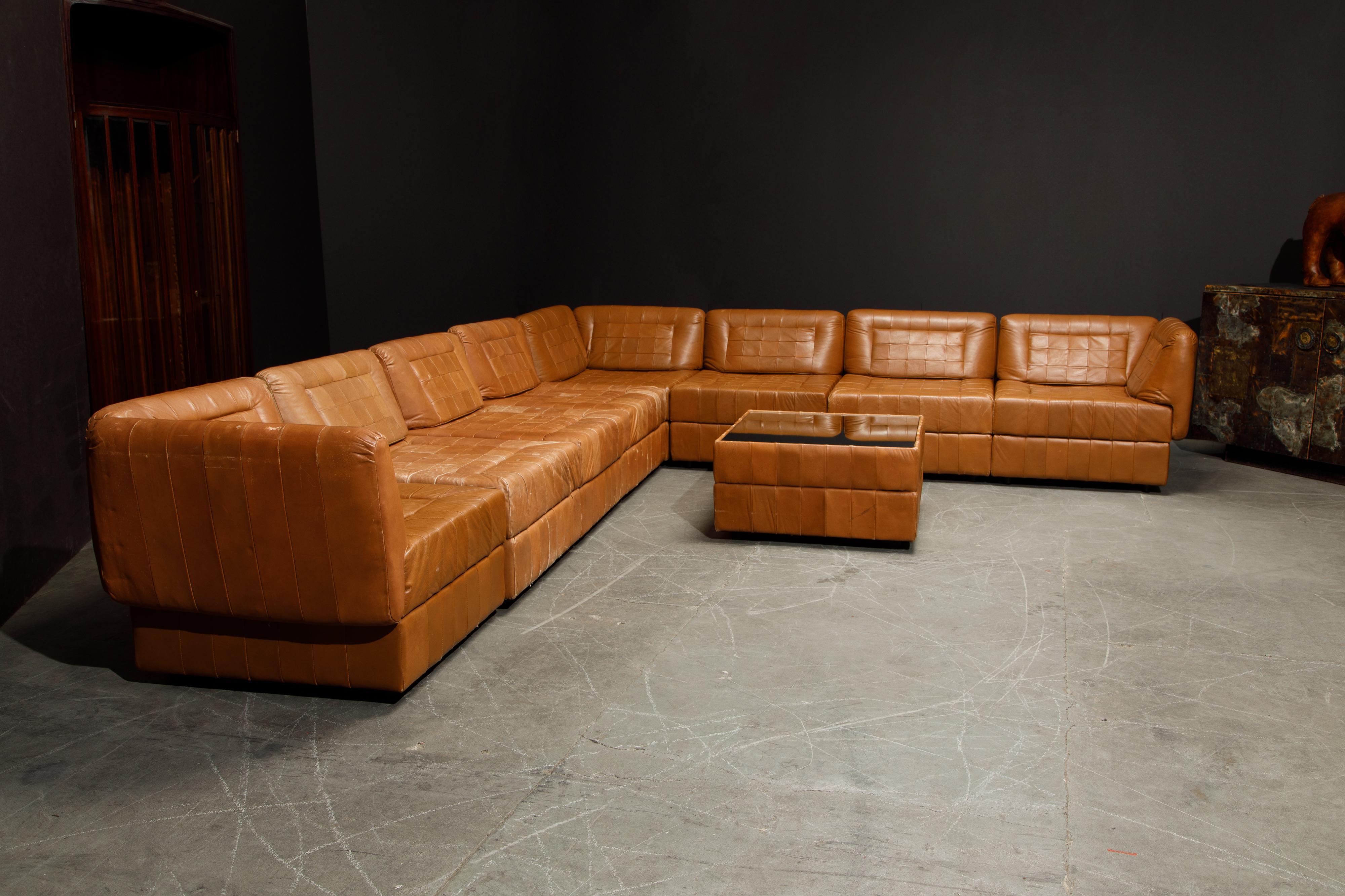 An impressive 1960s modular set of twenty-one (21) elements of cognac brown patchwork leather sectional living room set by Brazilian Modern designer Percival Lafer, signed with its original 'Lafer S.A.' / 'Made In Brazil' labels underneath each