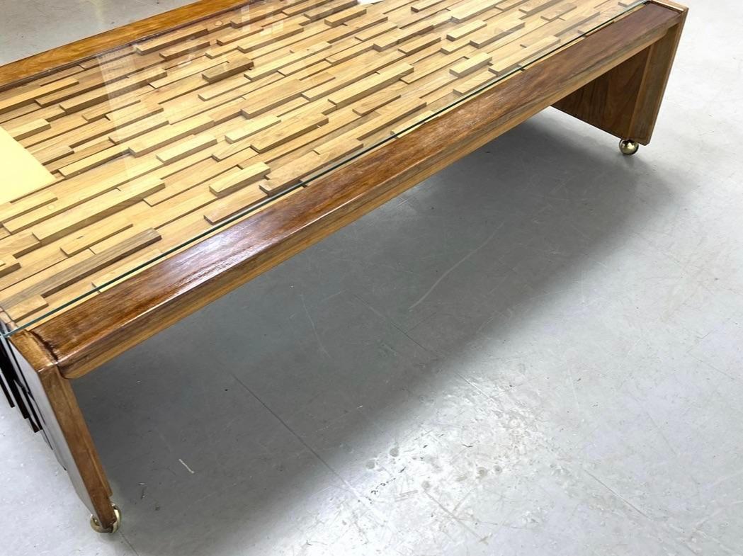 Vintage coffee table designed by Percival Lafer. Features a continuous mixed wood pattern of rosewood, mahogany, jacaranda, and teak with offset varying levels that is sure to make a statement in any space. Includes a protective glass top for easy