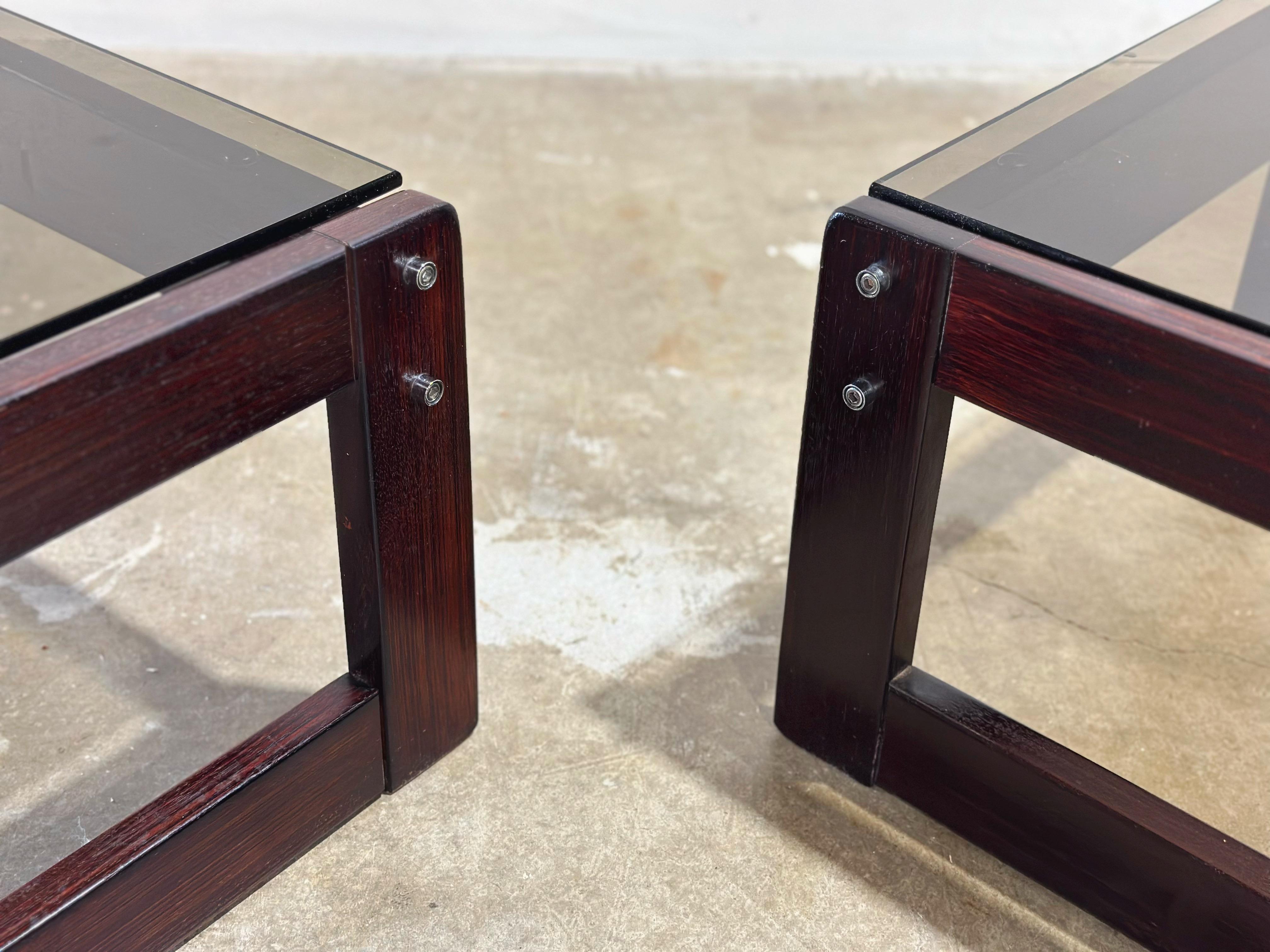 Pair of end or side table by Percival Lafer, Brazil, circa 1970s. 
Stout and modern Jacaranda wood frames with smoked glass tops and exposed chrome hardware. 
Frames are in excellent condition with no issues of note. Glass tops are free of any