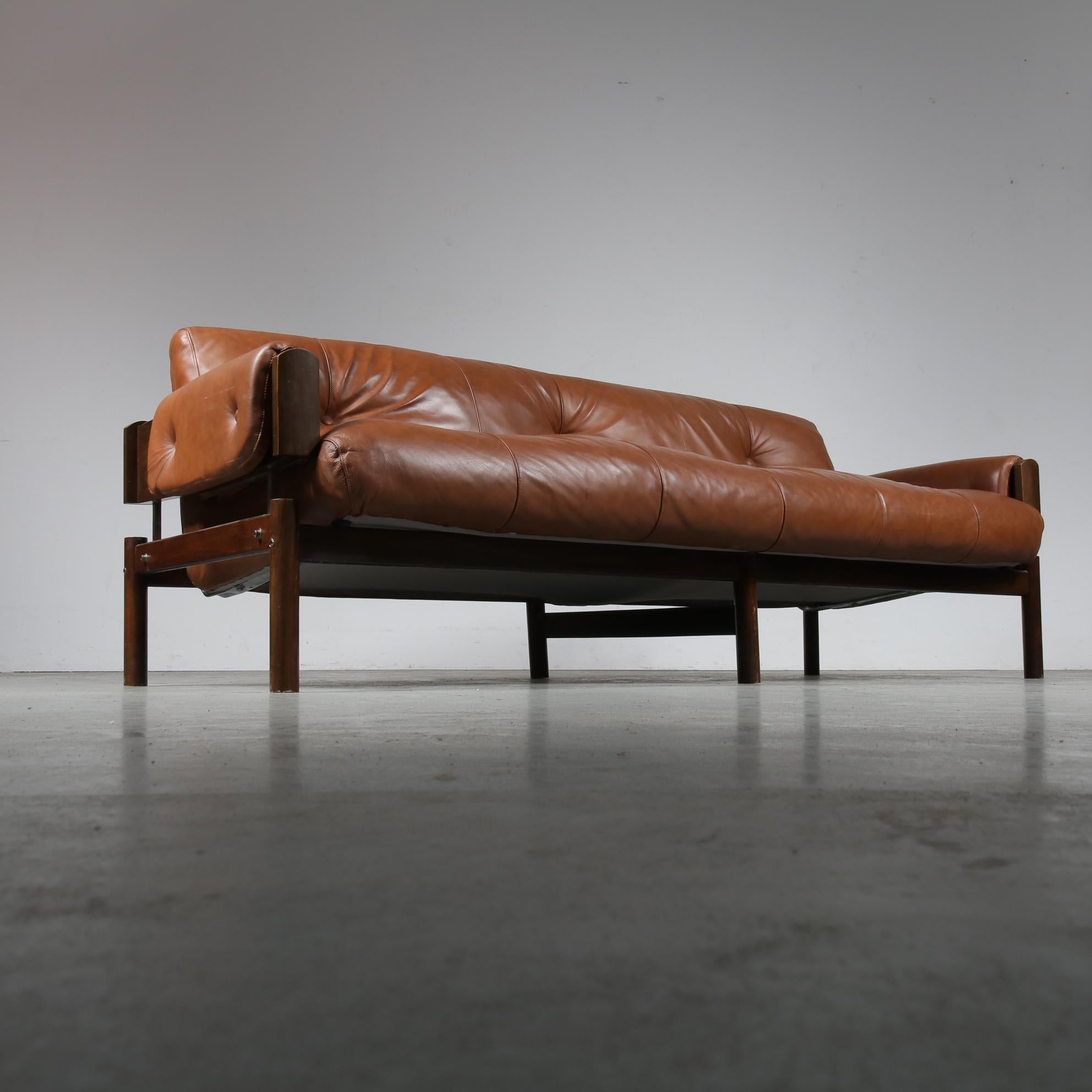 A wonderful sofa designed by Percival Lafer, made in Brazil in the 1970s.

The three-seater sofa is made of high quality, deep brown Brazilian hardwood. The comfortable seat, back and armrests are upholstered in high quality cognac leather, all