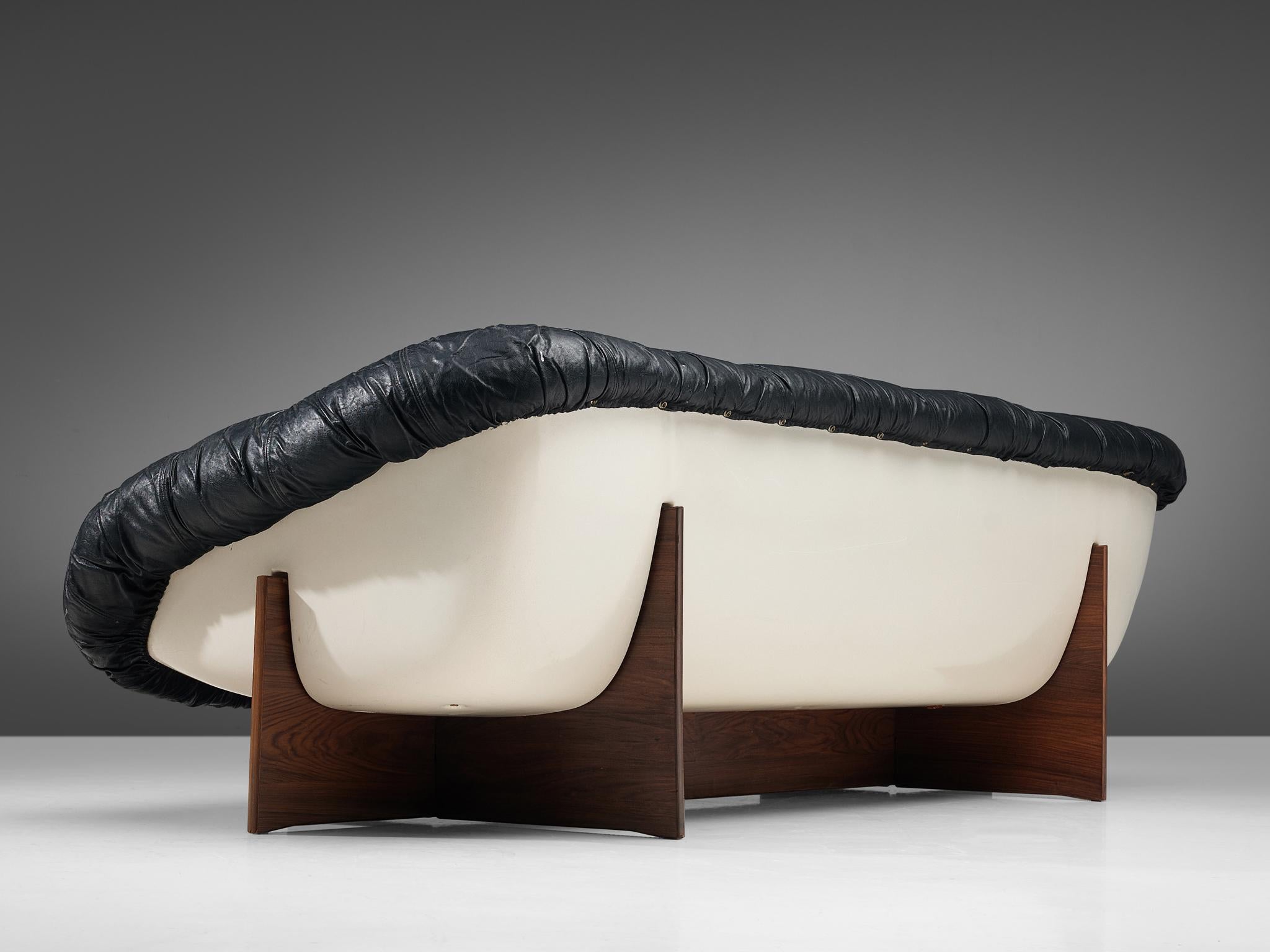 Percival Lafer, 'MP-61' sofa, Brazilian hardwood, leather and fiberglass, Brazil, 1970s

Bulky MP-61 sofa, designed by Percival Lafer in the 1970s. This sofa consists of a fiberglass shell which is white lacquered. It holds the black leather seat,