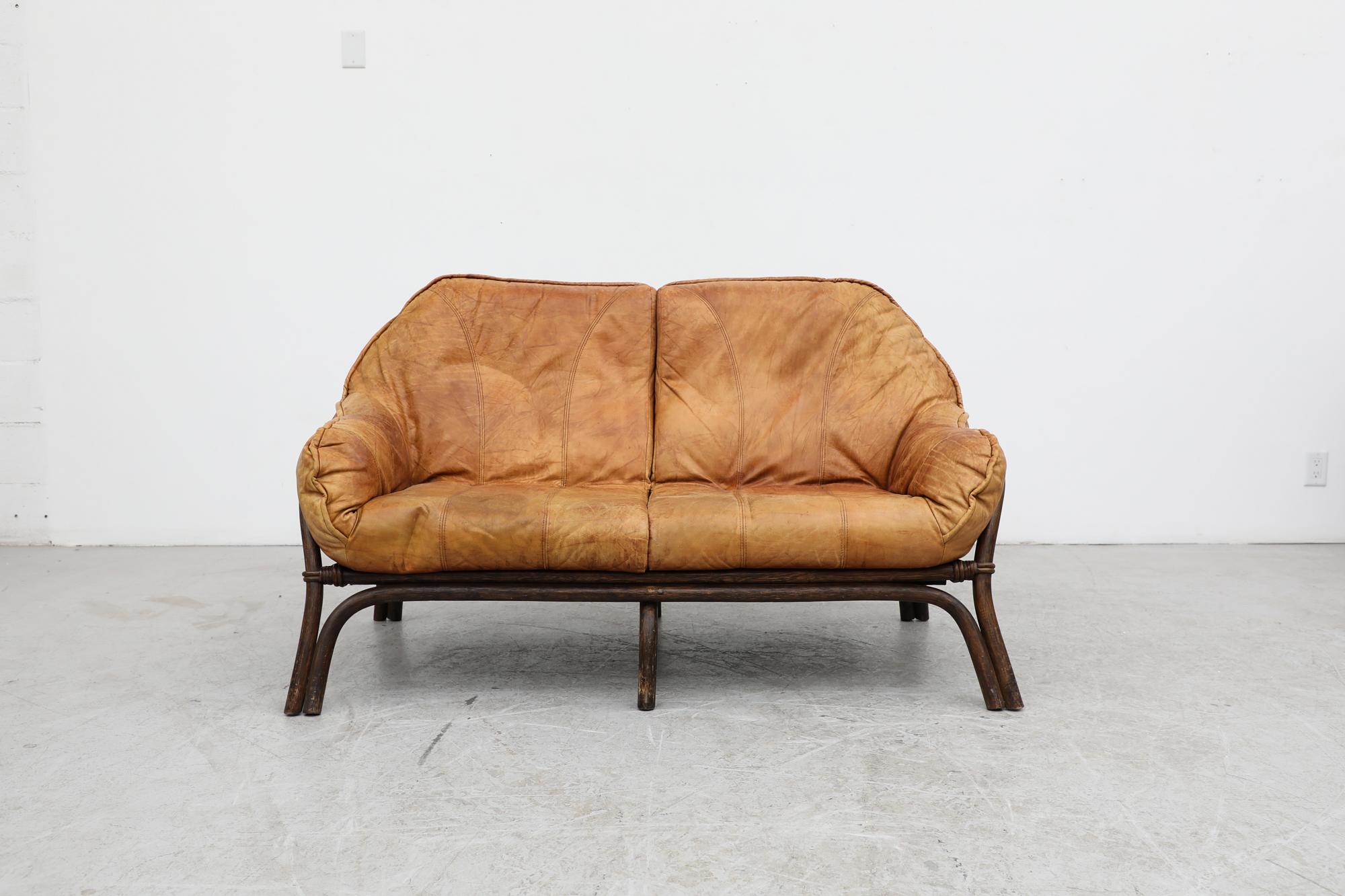 Percival Lafer style brutalist bamboo loveseat with cognac leather cushions. In original condition with a handsome patina and wear consistent with its age and use. Other bamboo pieces are available and listed separately.