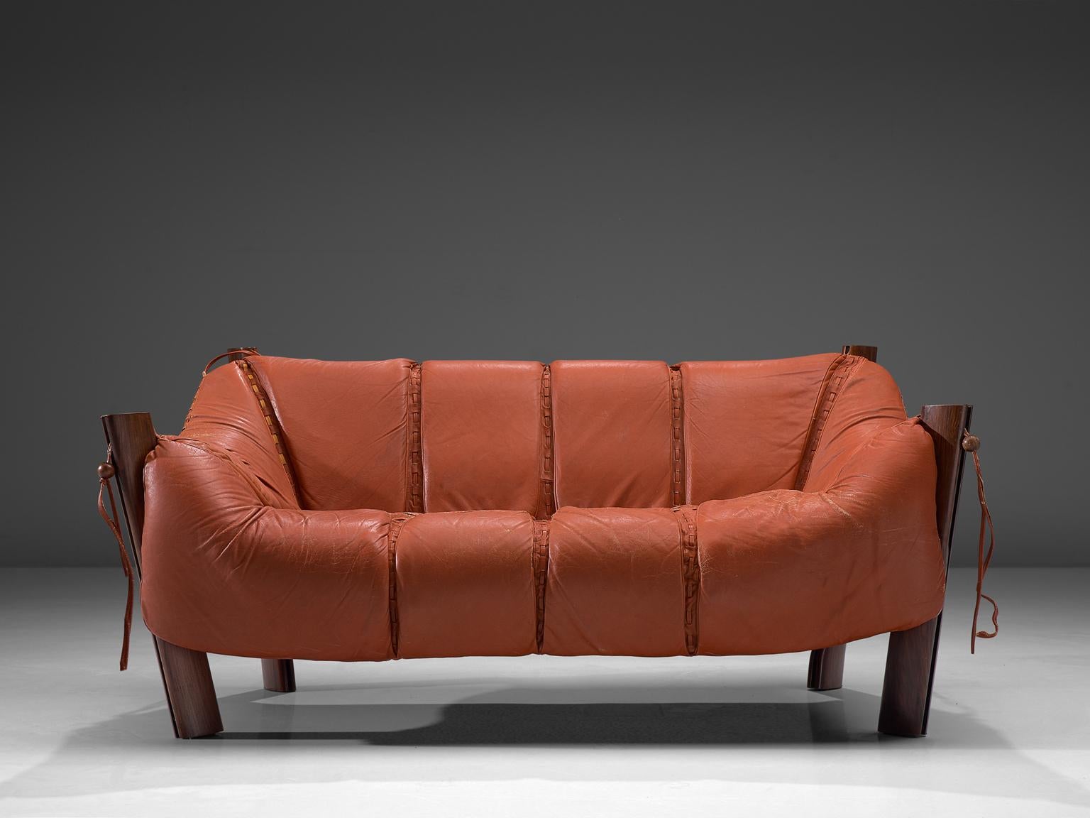 Percival Lafer, Sofa model MP-211, in wood and leather, Brazil, 1974. 

Two-seat sofa by Brazilian designer Percival Lafer. This sofa consists of a solid Jacaranda base in which the leather seating 'hangs'. Soft cushions are folded over the