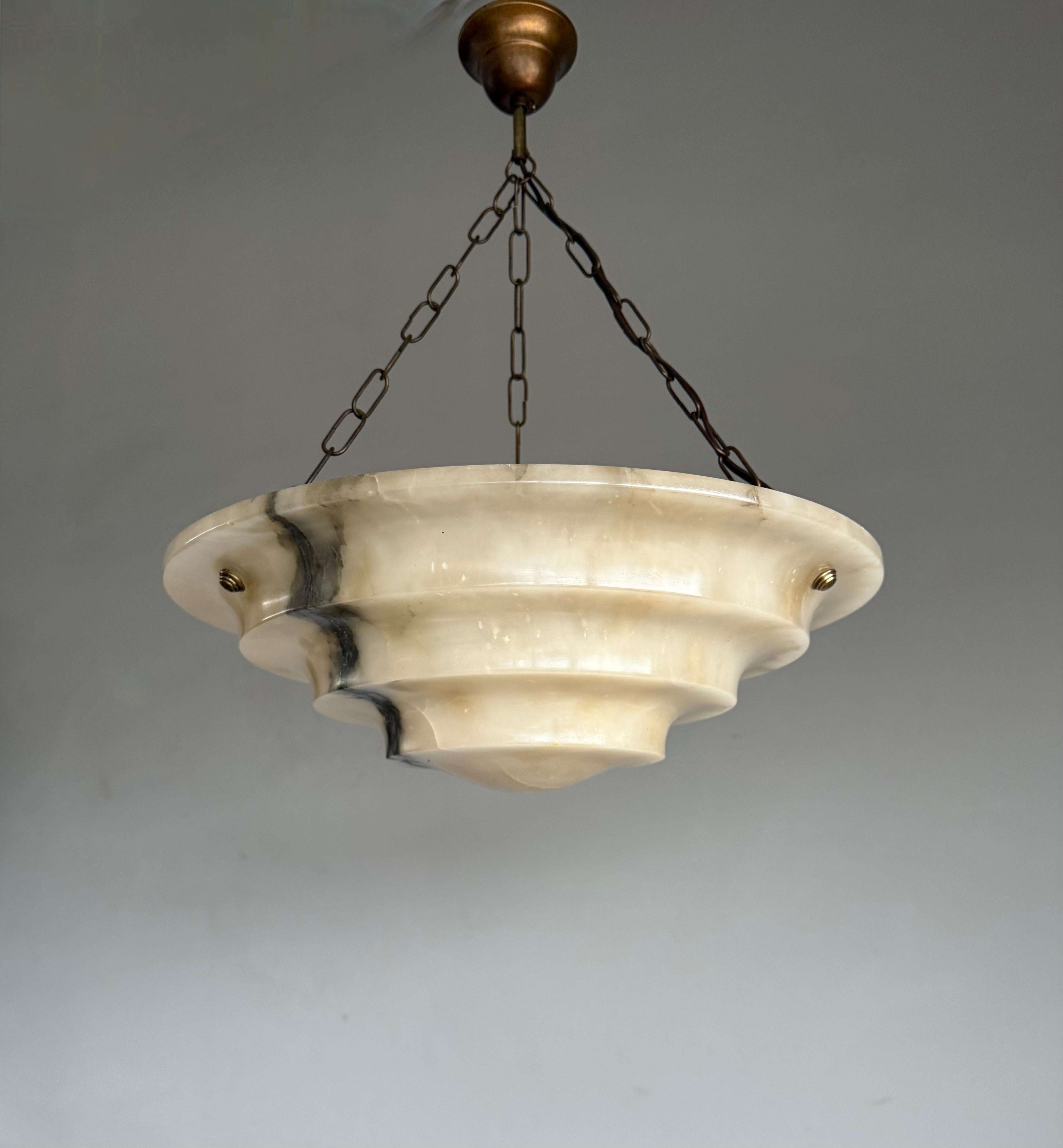 Rare and very stylish, good condition and warm color alabaster 3-light pendant of great quality and design.

This rare Art Deco fixture from the heydays of the European Art Deco era is another one of our recent great finds and it too will light up