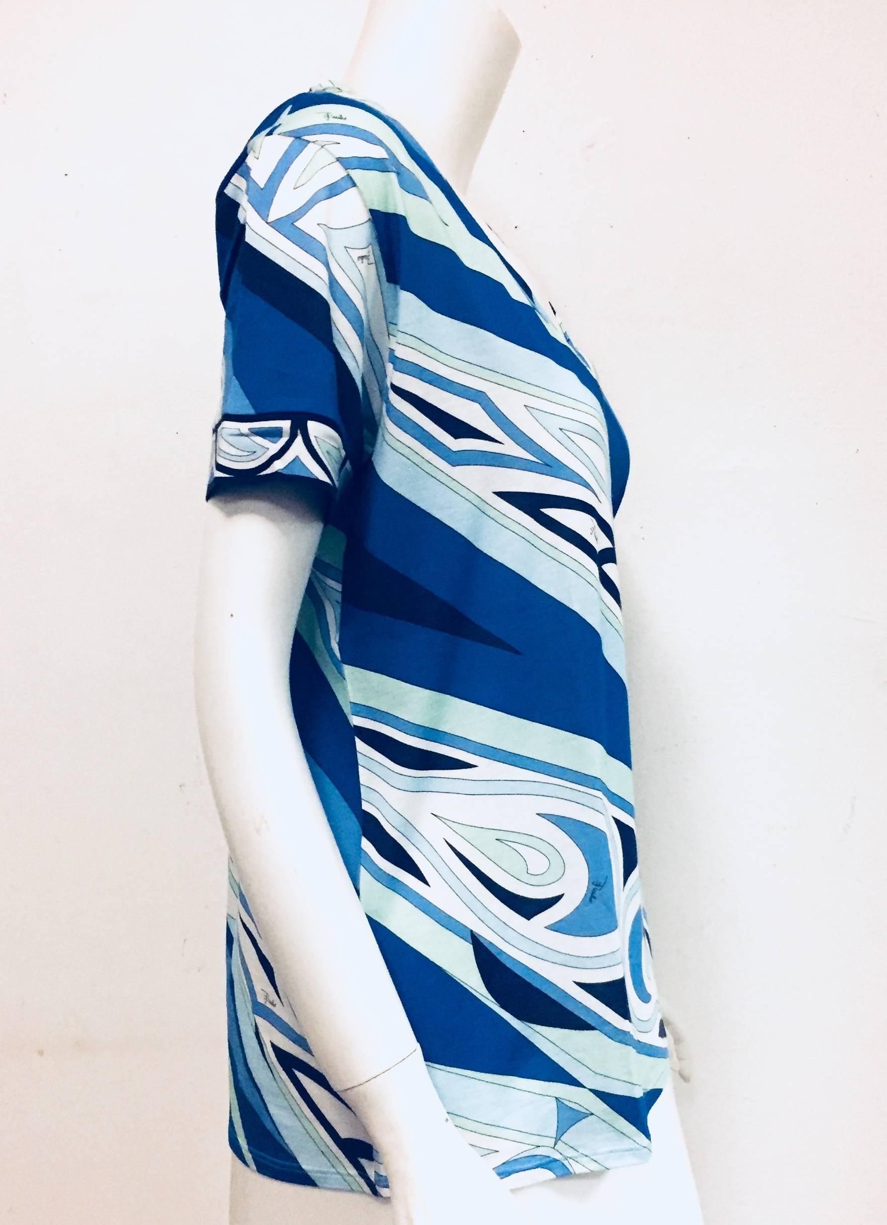 Emilio Pucci's mastery of color in tones of blue and print is evident on this vibrant top. Crafted in Italy from lightweight cotton.  The V neck and short sleeves of this casual Pucci top will combine fabulously with a pair of distressed jeans or