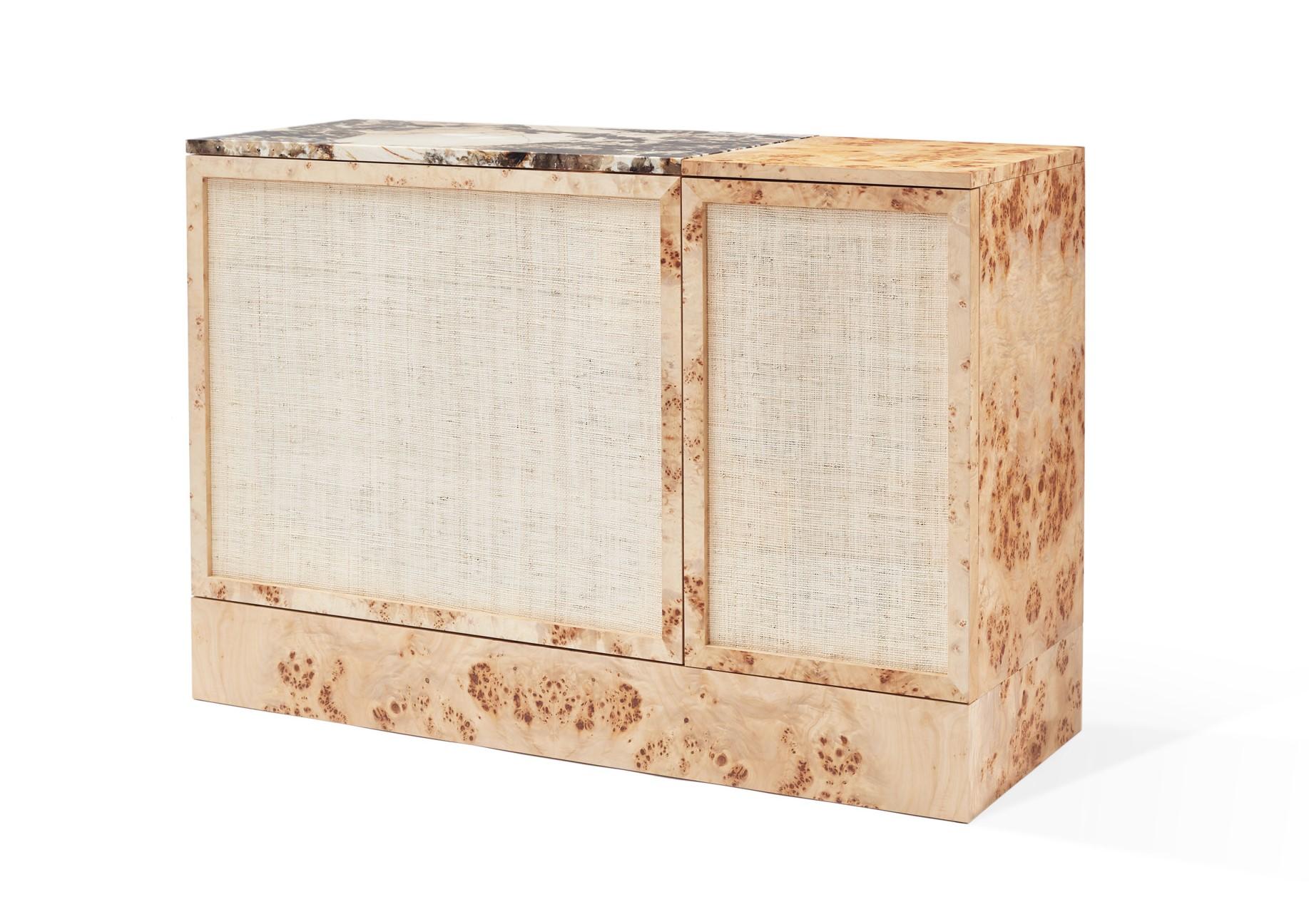The monolithic lines of the piece contrast with the delicacy and elegance of its materials. The poplar root wood combined with the natural rattan confer the piece a natural character in a clear compliment to its origins, whilst the exotic stone top
