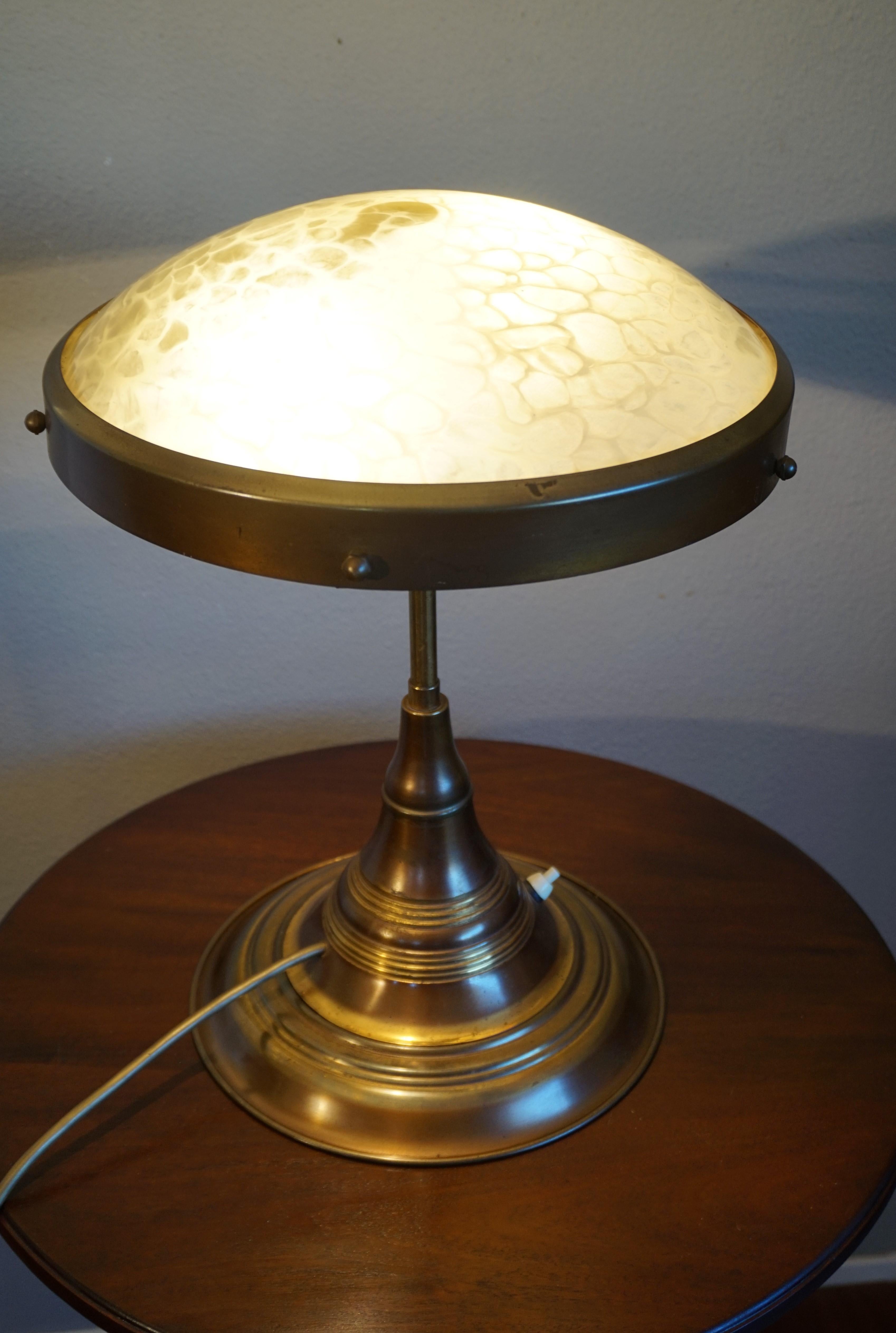 Beautiful and practical 1920s desk lamp.

This sizeable and great looking Art Deco desk lamp has the most beautiful look and feel, both on and off. The shape and size of the base makes this desk lamp stand as stable as the day it was made and the