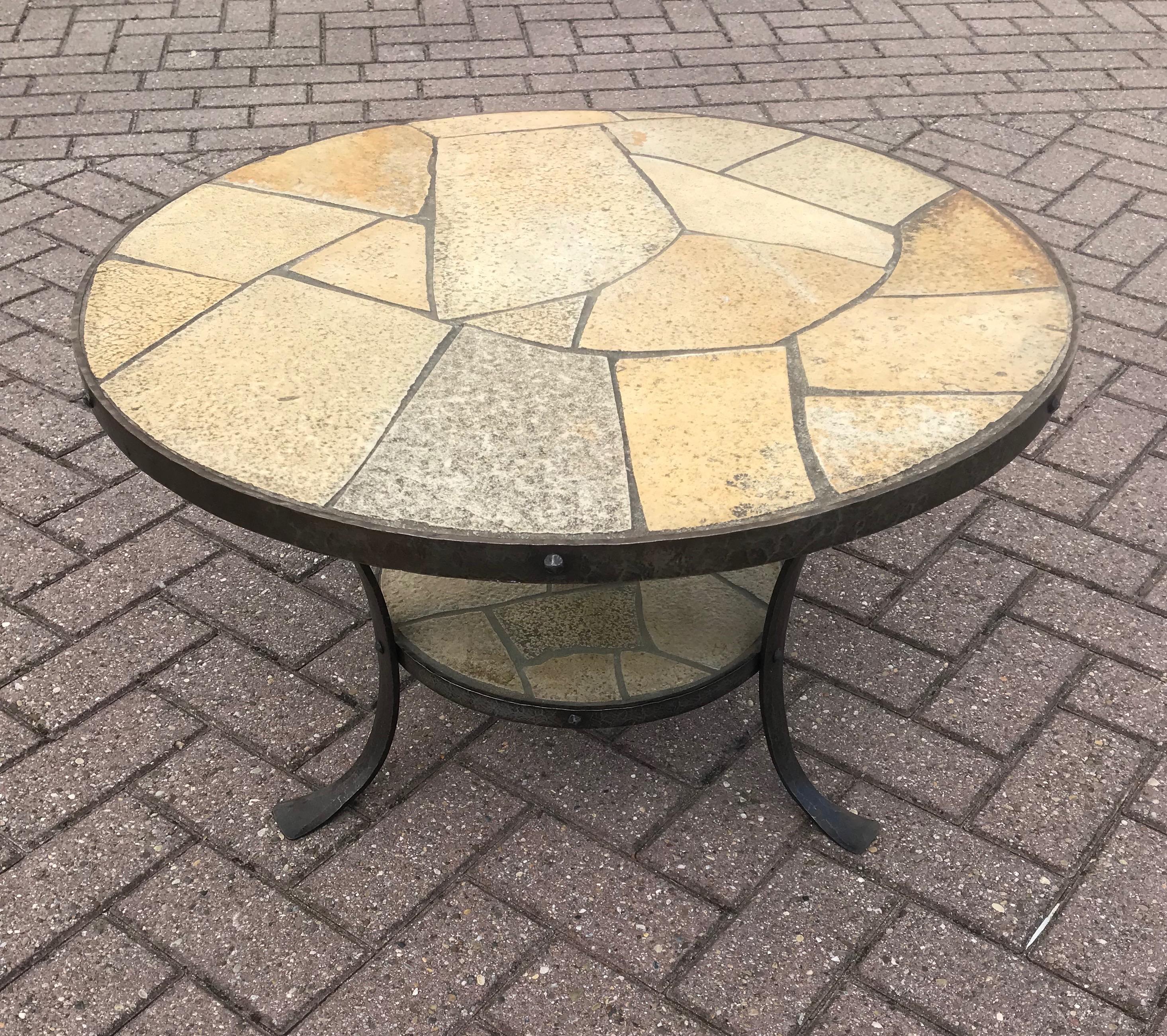 Stunning handcrafted round shape coffee table.

This super sturdy and highly stylish wrought iron table with slate stone top and first tier is in excellent condition. The quality hand-forged frames around the stone inlaid tiers are beautiful and the