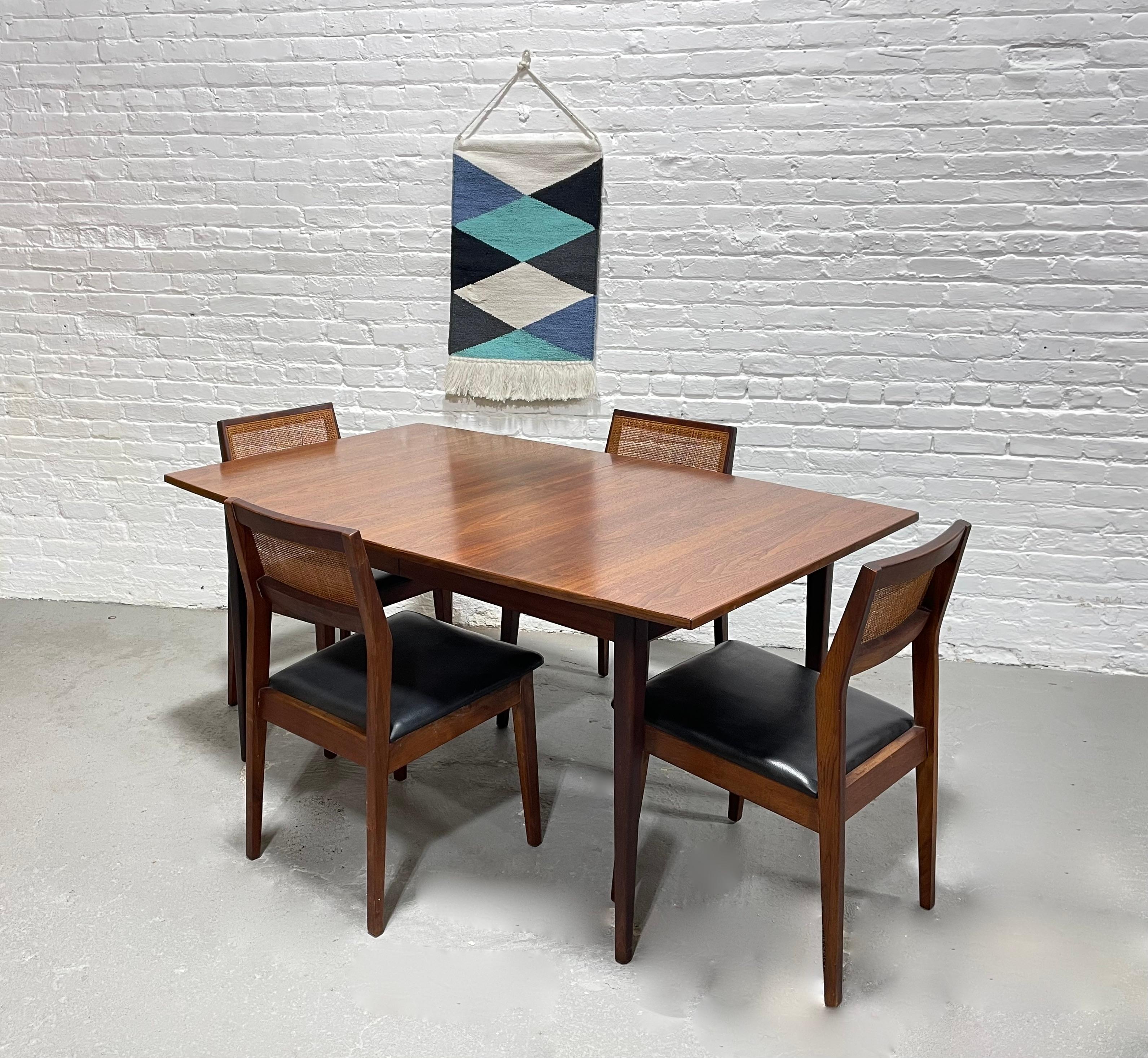 Perfectly sized Mid Century Modern WALNUT DINING TABLE, c. 1960's. Comfortably seats 4-6 guests yet won't overwhelm a room. Solidly built from walnut wood with some of the most gorgeous wood grains we've seen on the newly refinished tabletop.  The