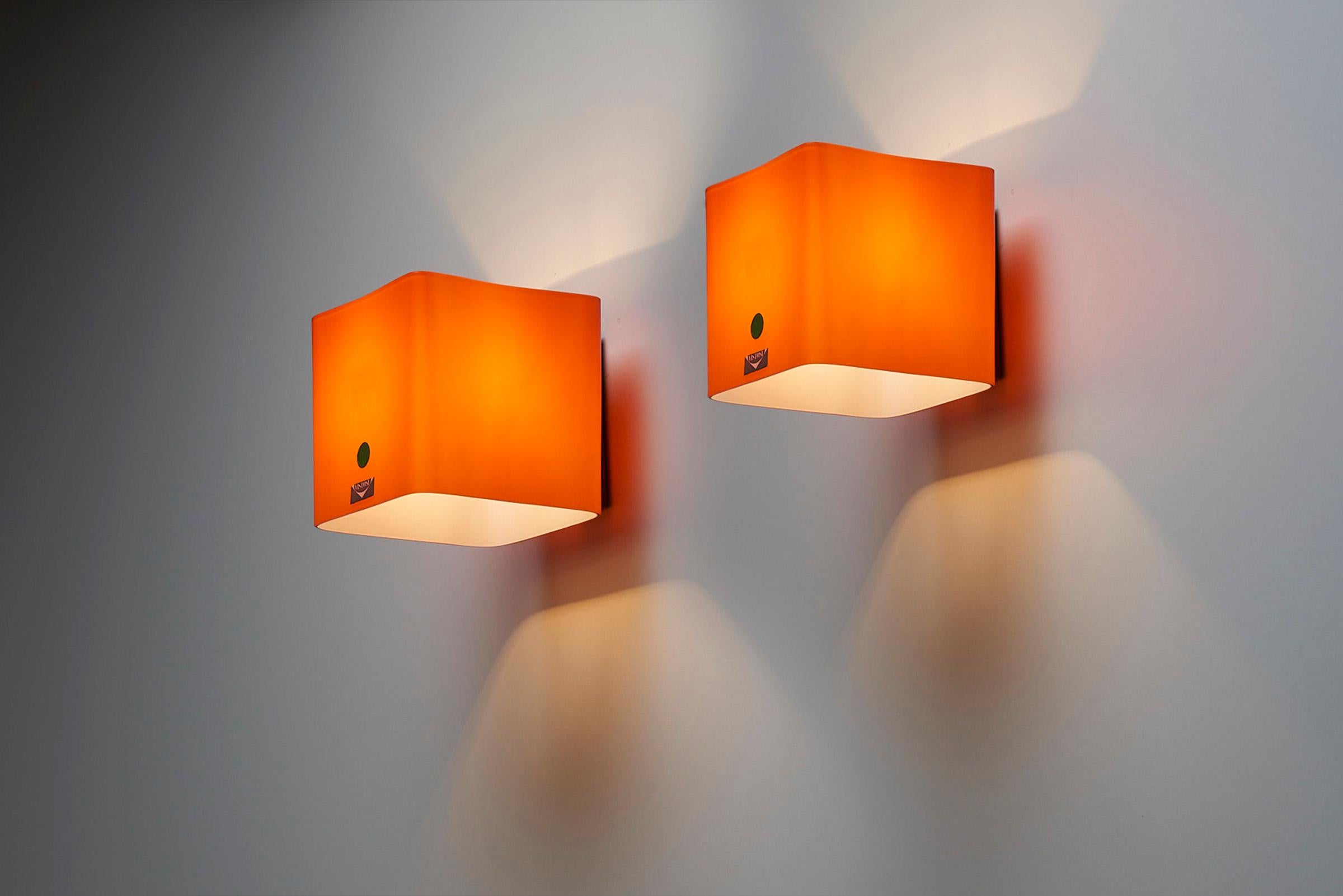 Introducing a captivating set of 2 Orange Murano Glass Wall Sconces, showcasing the exquisite craftsmanship of Vistosi Italy.

These wall sconces embody the perfect fusion of artistry and functionality, with their kubic form and vibrant orange