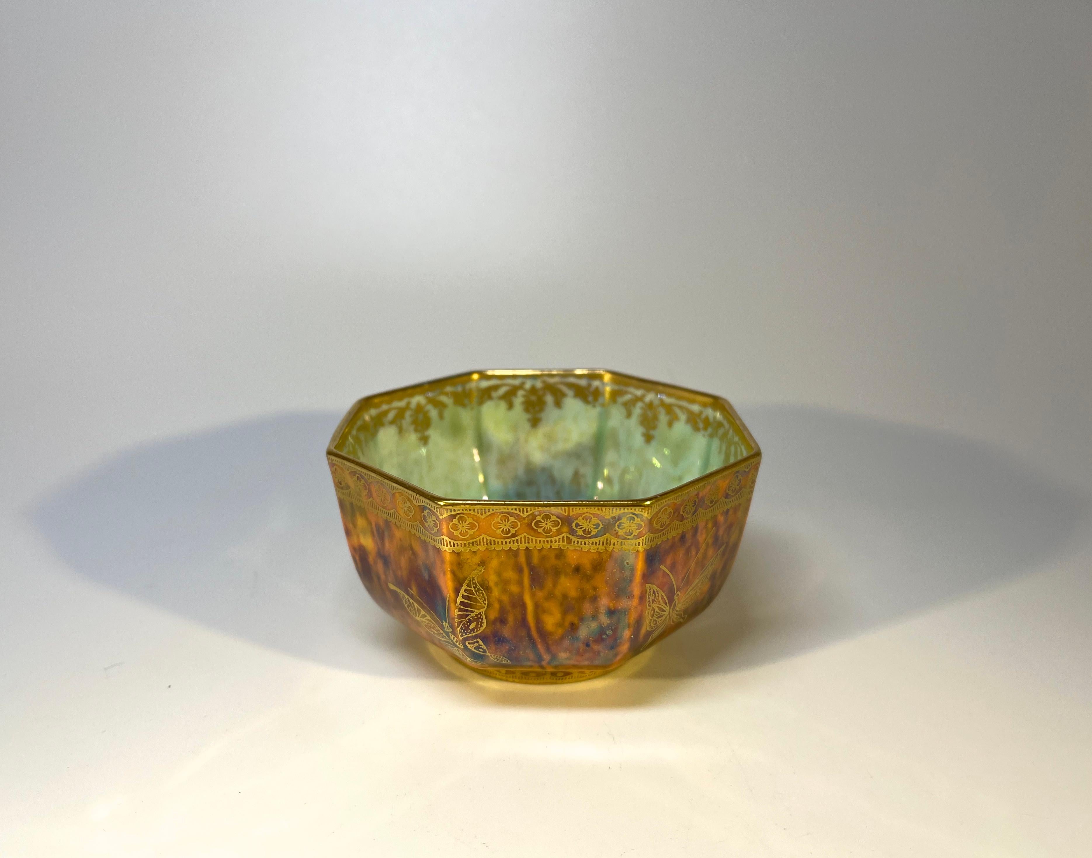 Absolutely delightful and delicate Daisy Makeig-Jones for Wedgwood, octagonal bone china lustre bowl.
The interior is decorated with mother-of-pearl coloured mottlings, a bold gilded central scarab motif and gilded filigree decoration
The exterior