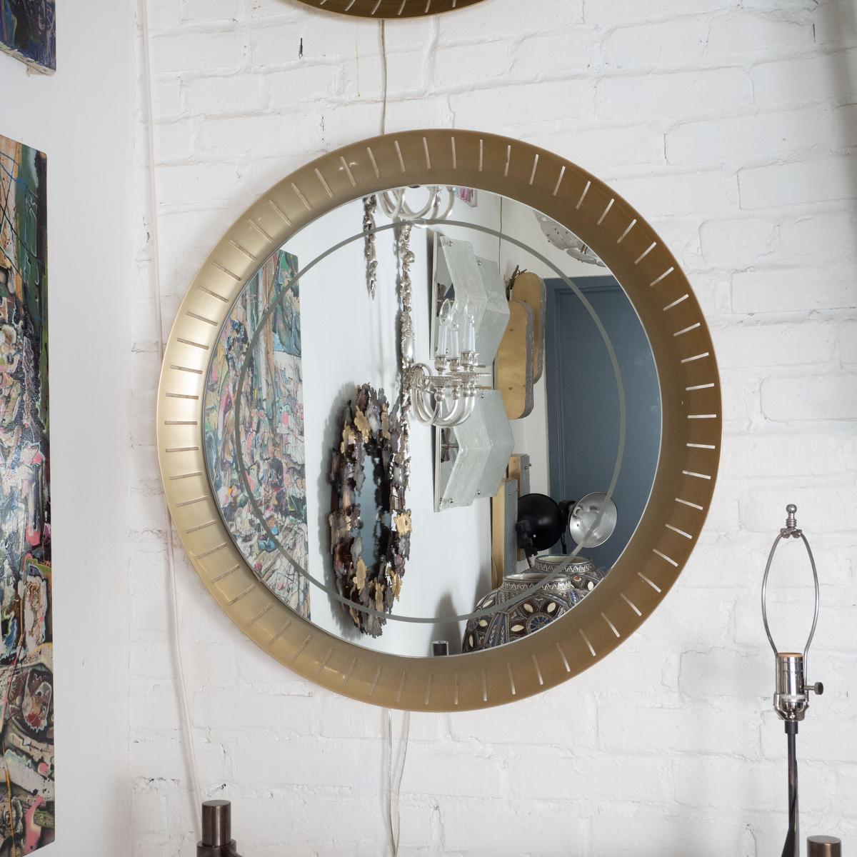 Perforated, concave brass, backlit mirror by Hillebrand in the style of Stilnovo. Newly replaced mirror with frosted trim detail. Uses fluorescent ring style bulb.