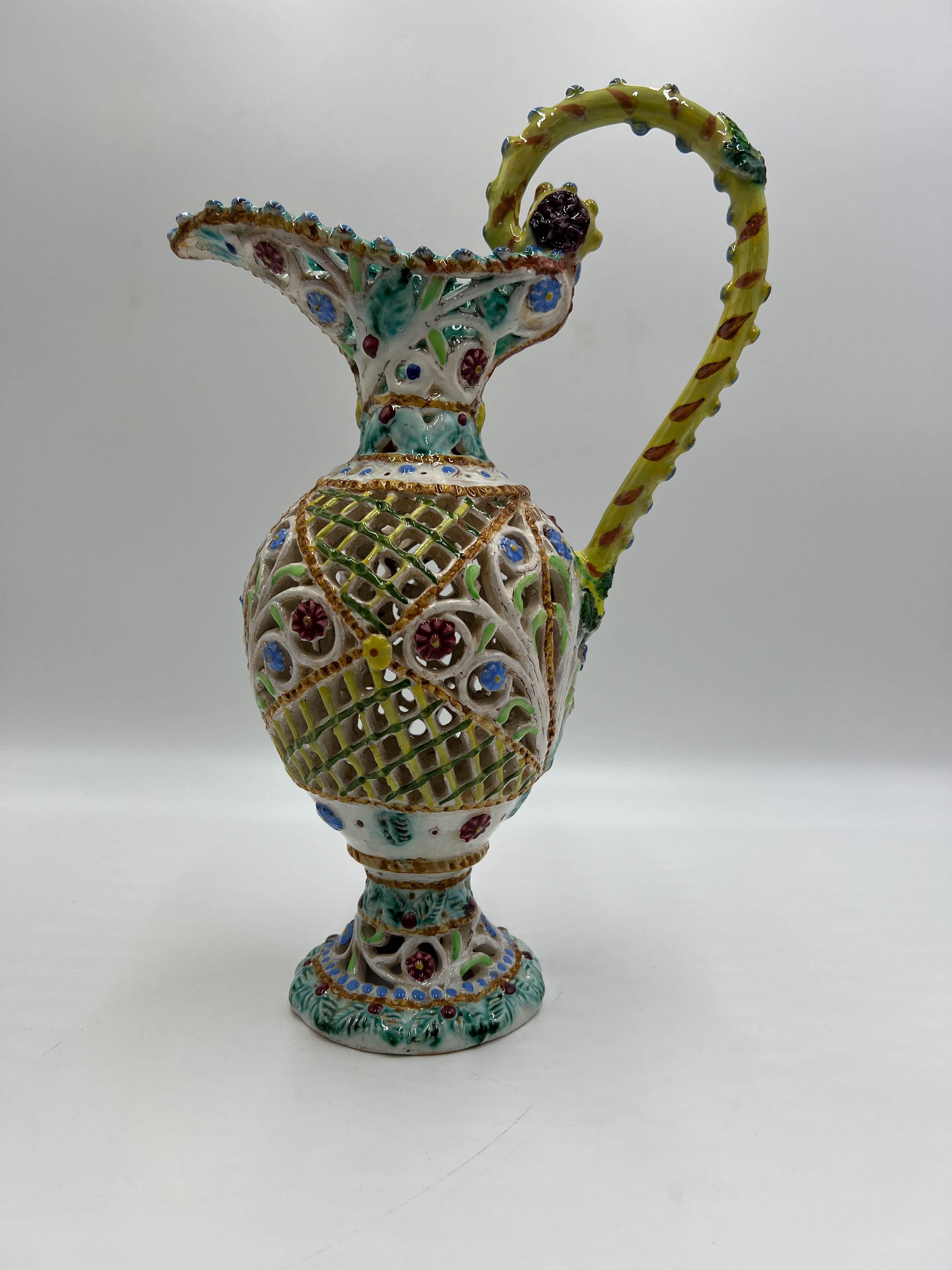 A very rare specimen of a perforated ceramic pitcher made by Giovanni Lapucci in Monte San Savino, located in the Province of Arezzo, Italy. 
The Lapucci Ceramic Laboratory was established in Monte San Savino by Giovanni Lapucci in 1922, where