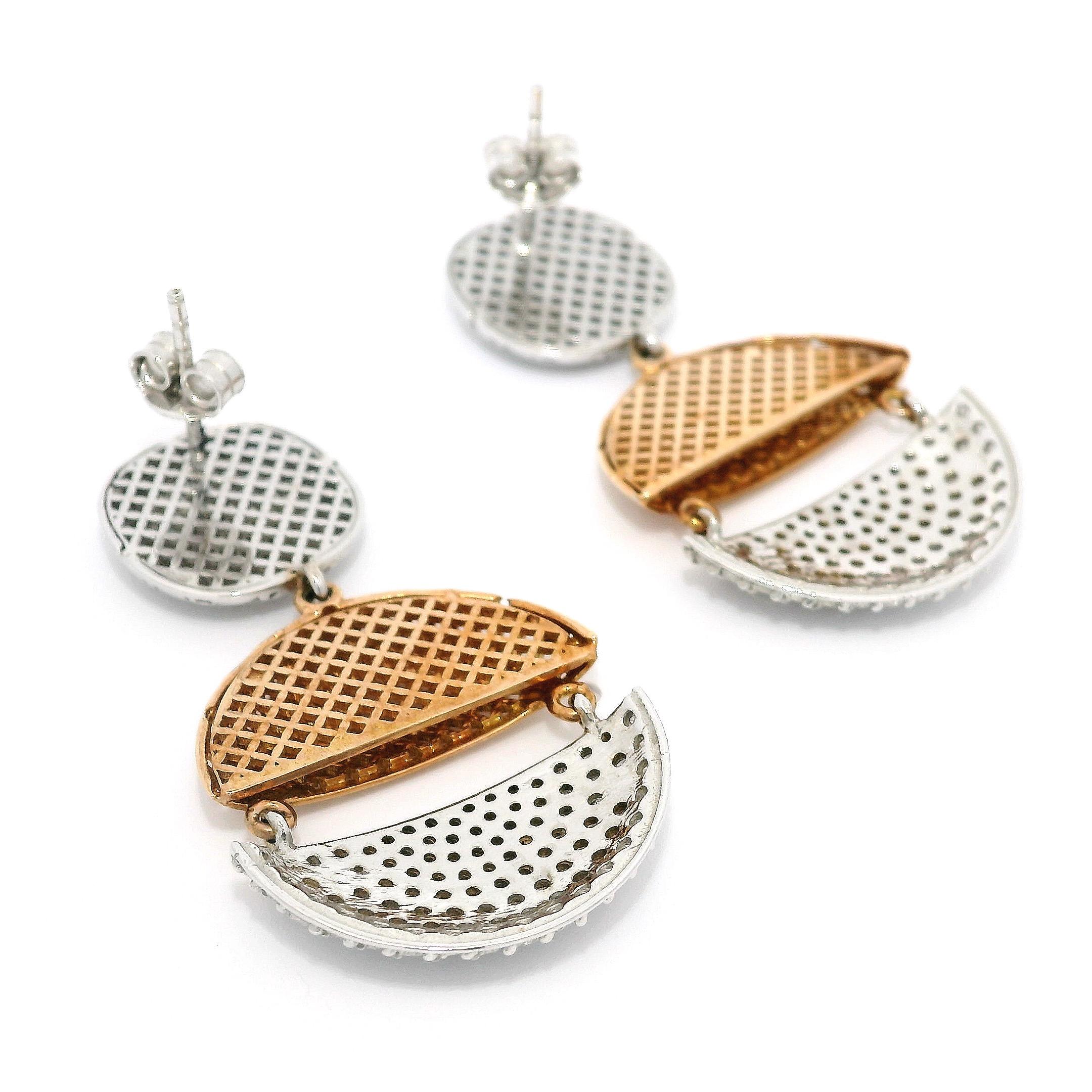 Elevate your style to new heights with our captivating Perforated Dangling Flat Button Pavé Diamond Earrings in 18K White and Rose Gold. These earrings seamlessly blend timeless elegance and on-trend sophistication, making them a must-have accessory