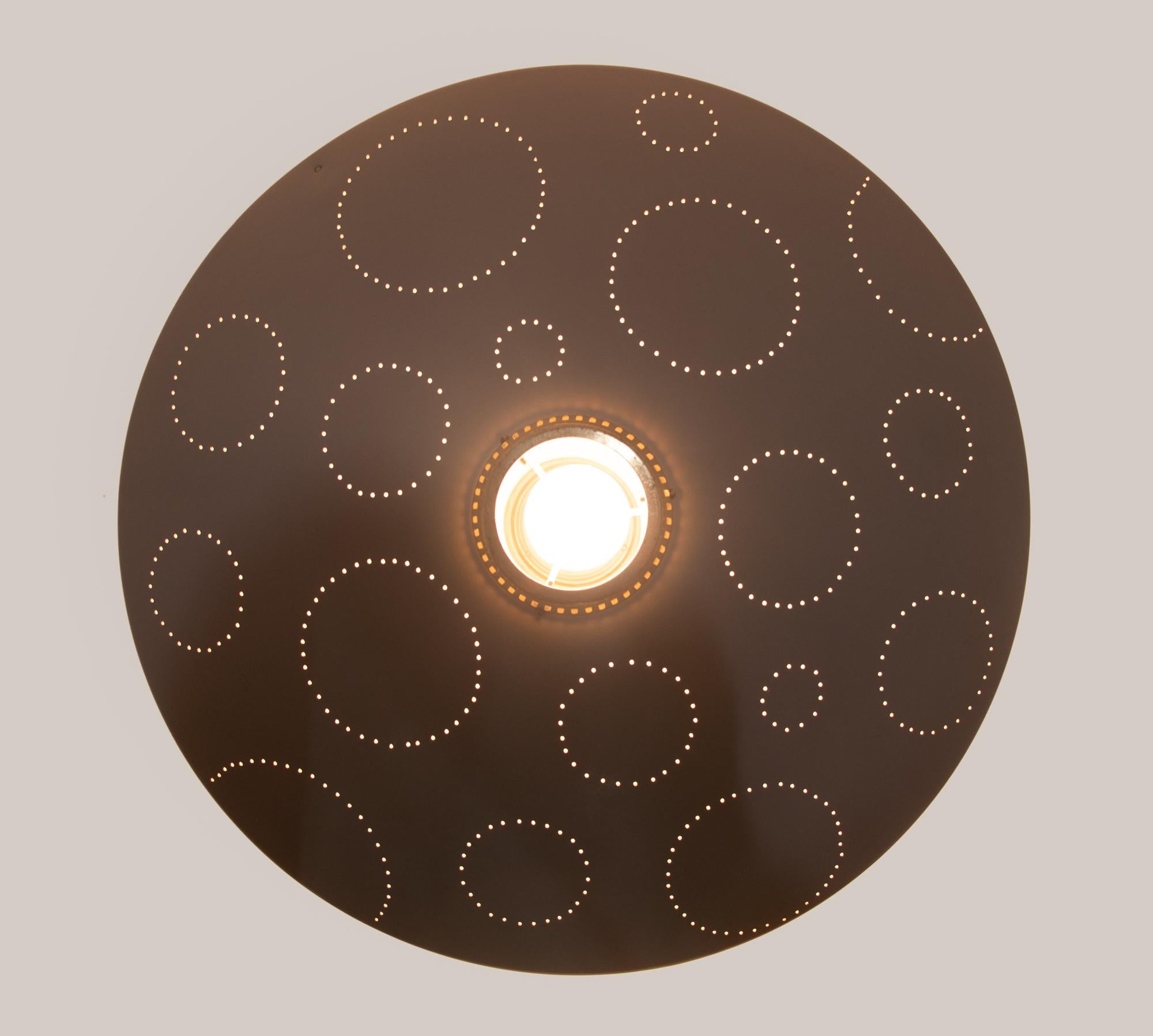 Elegant flush mount ceiling light comes with a disc shaped enameled metal reflector with circular perforations of different sizes and a small round brass diffuser. Original colored enamel. Manufactured by Belmag, Zurich Switzerland, circa 1950s.