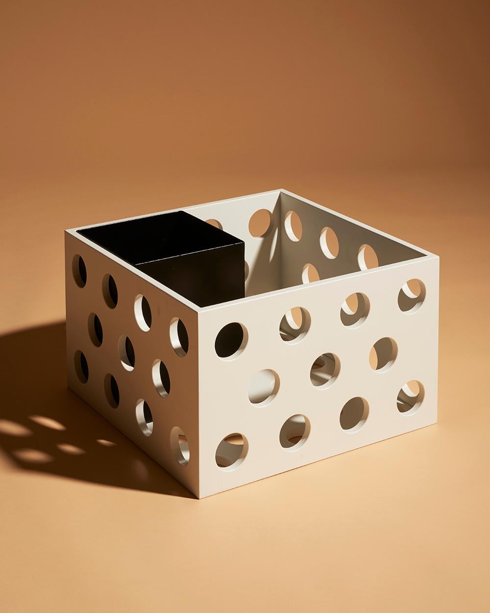 Wooden storage box made in holed solid birch wood. Large holes creates a distinct graphic look and allows light to flow through. The boxes are light and easy to hold. They work both as stand alone units for storage or stacked on top in endless
