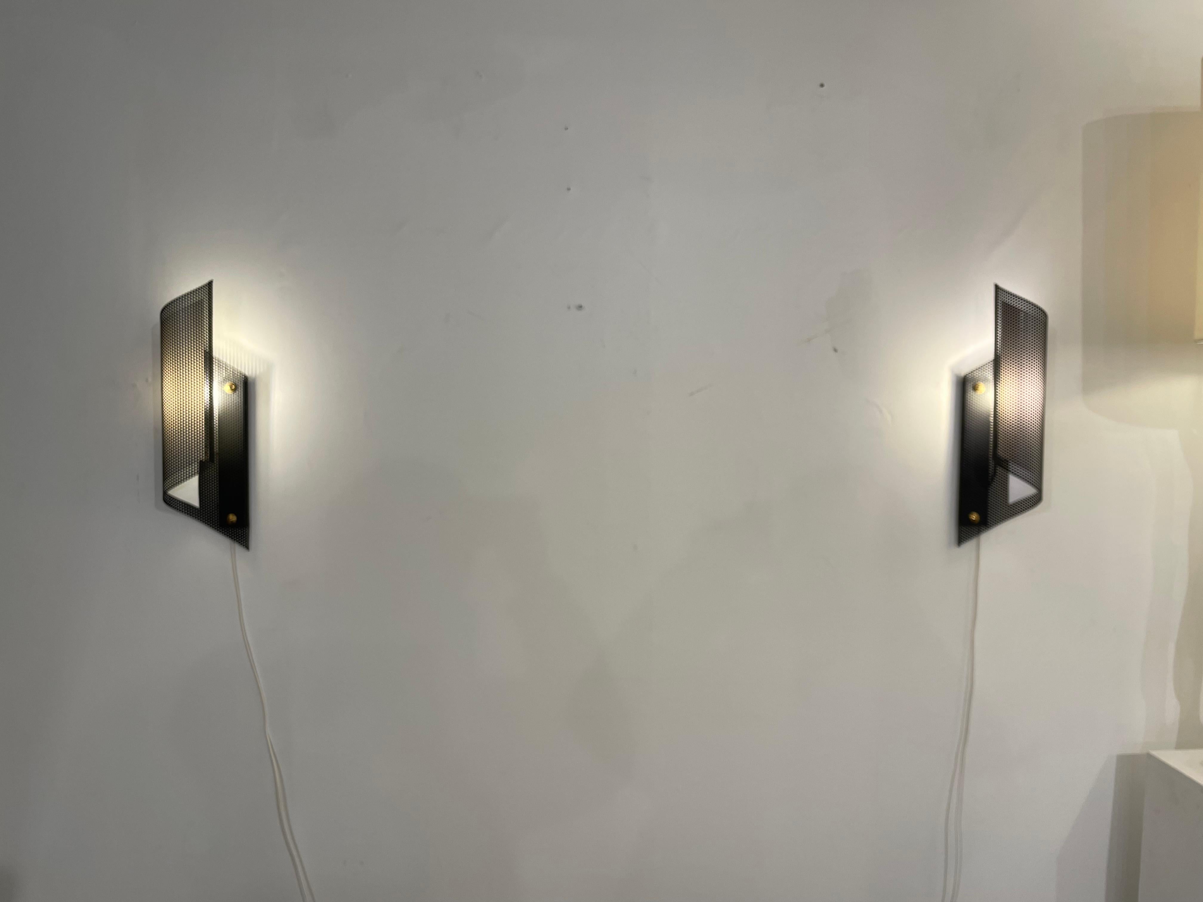 Perforated metal sconces by Lunel from 50.