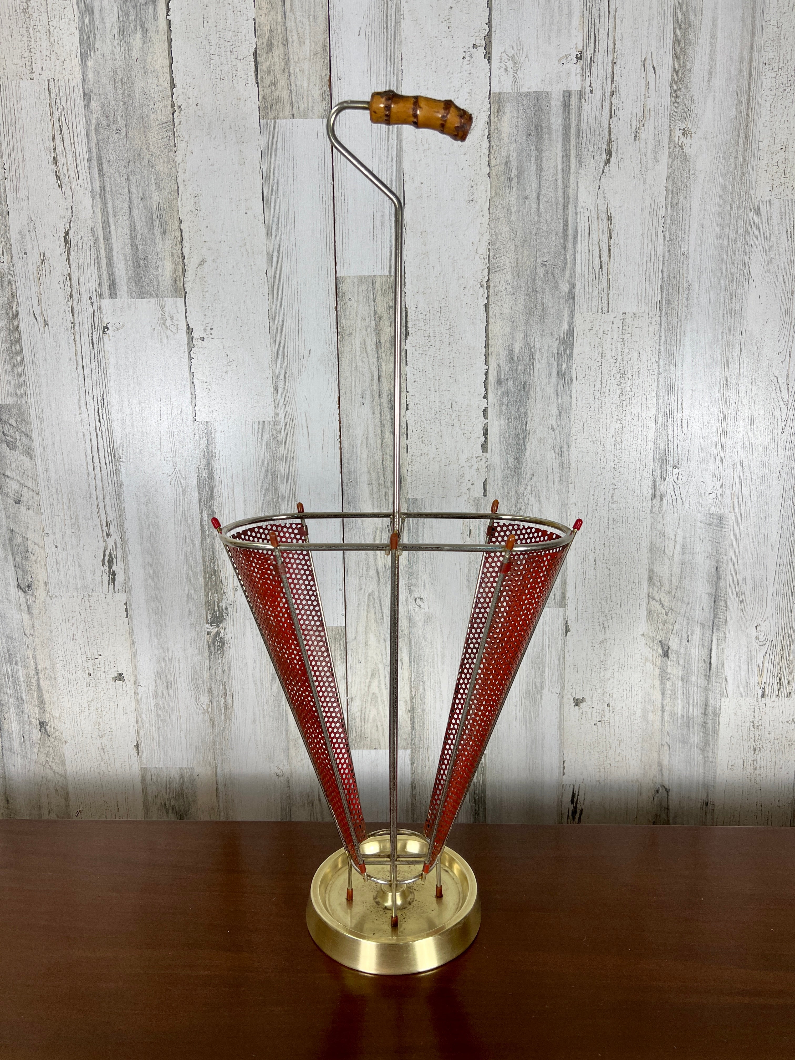 Perforated metal with original red paint and a combination of brass base with chrome frame, topped with a faux bamboo handle.