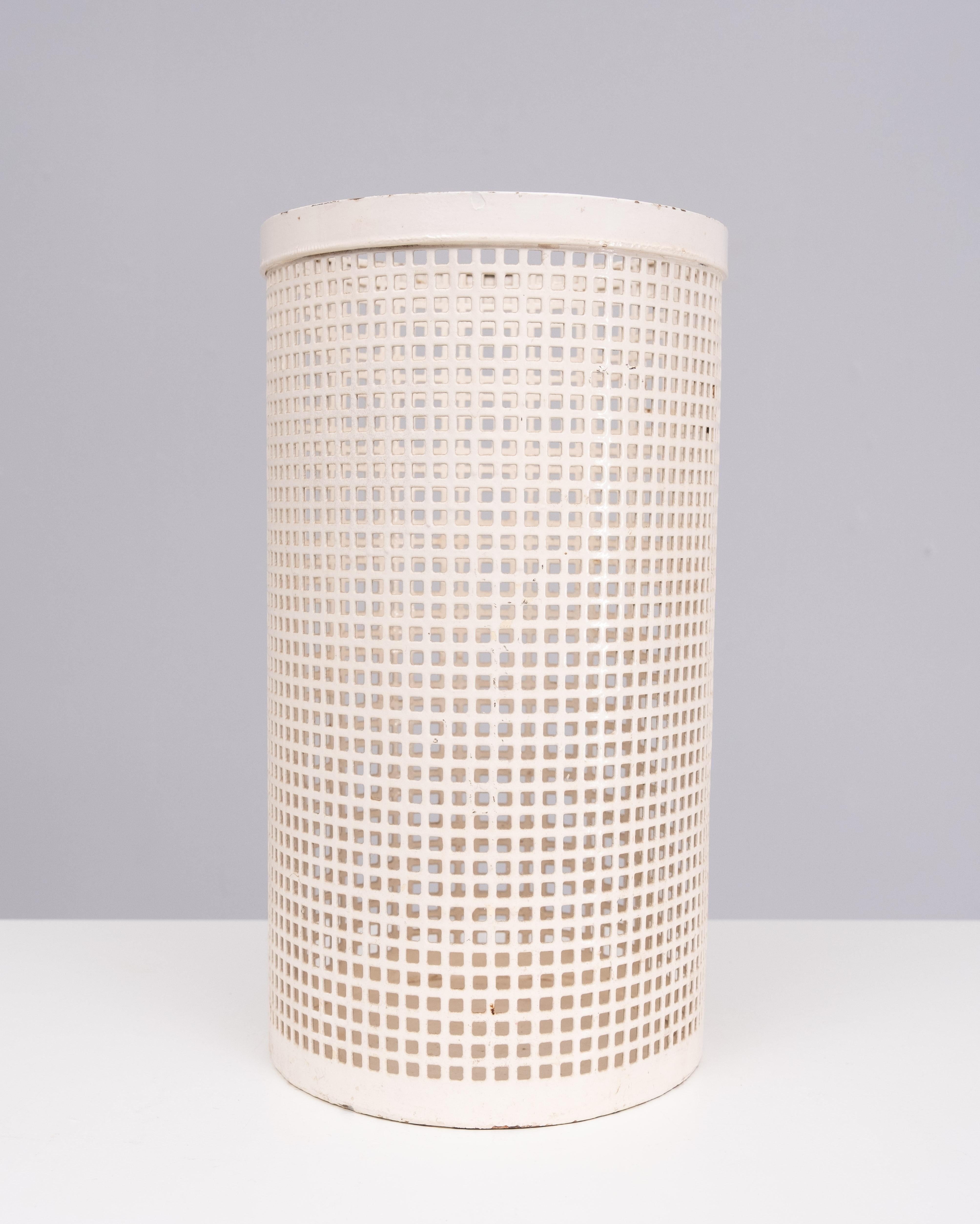 Perforated  Metal Paper basket . Very robust and heavy basket .
 oval shape. Once repainted in a off White color .
